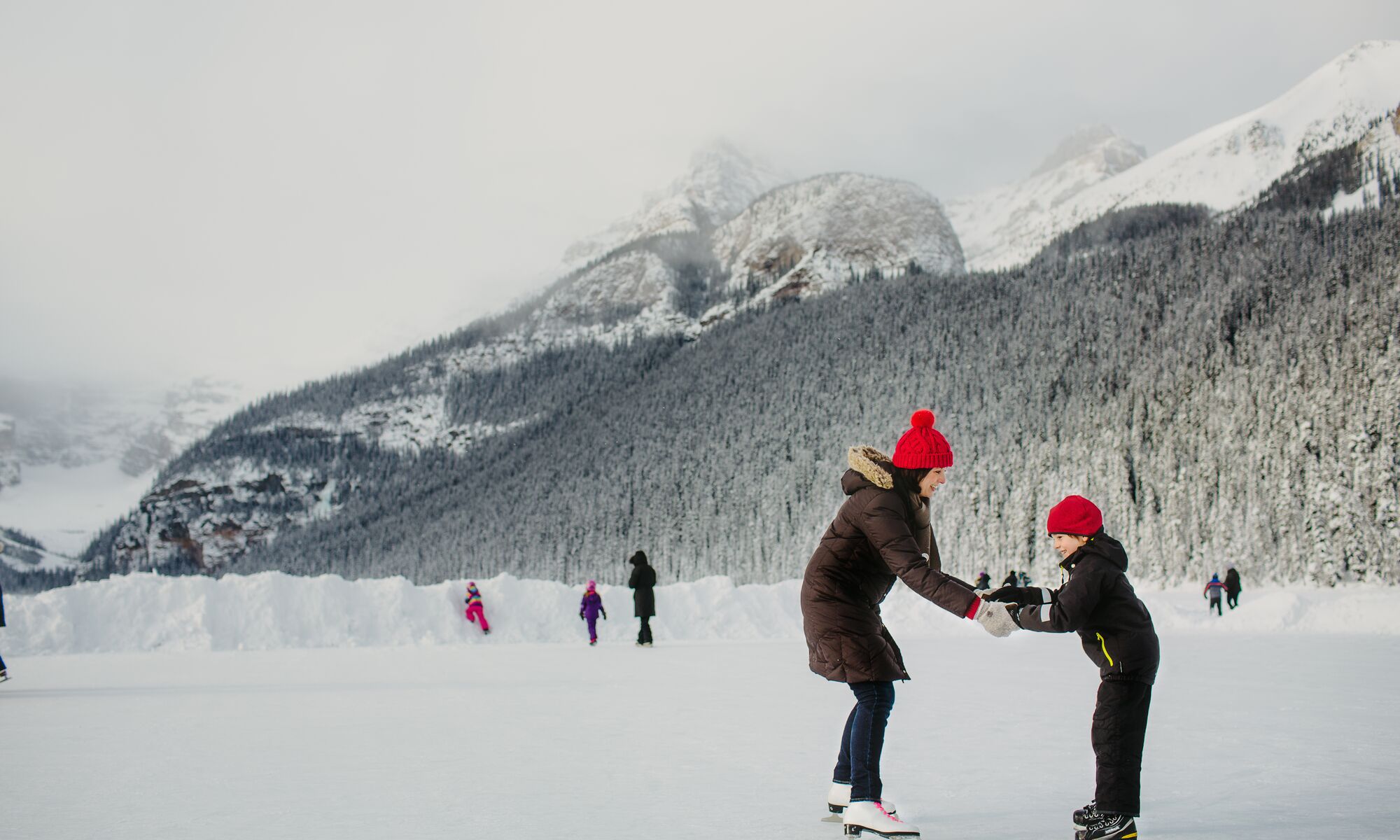 A family skating on Lake Louise in Banff National Park