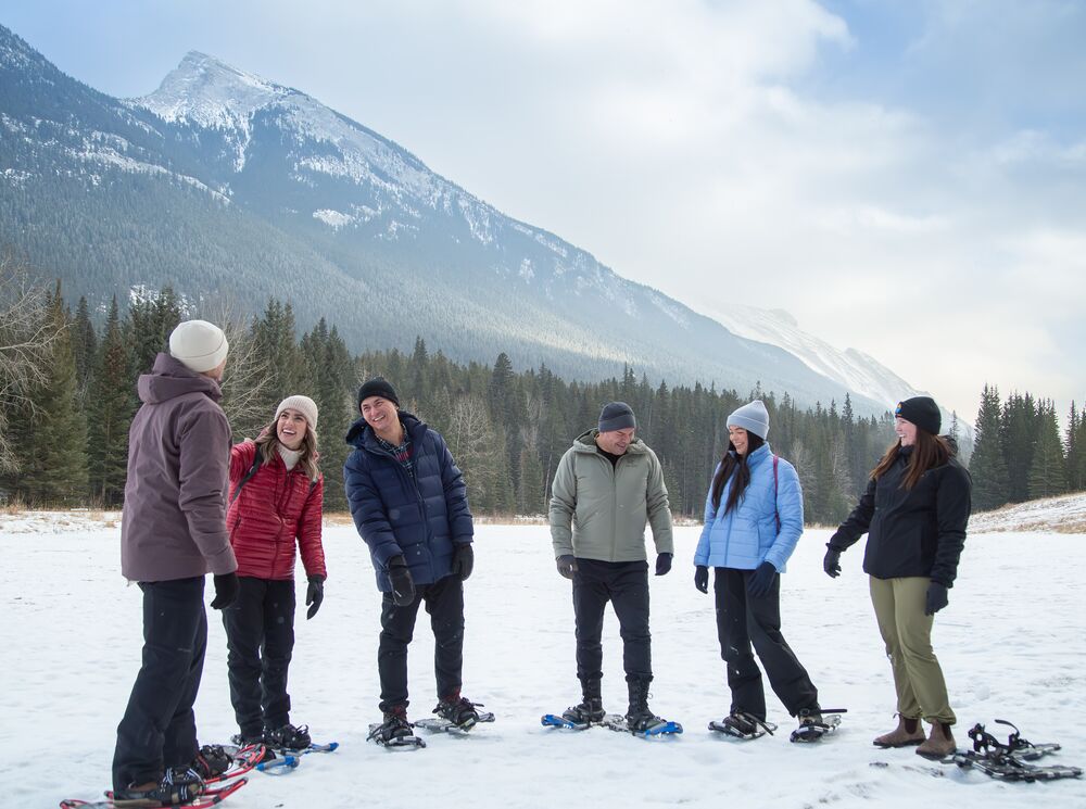 A group of 6 people snowshoeing in Banff National Park