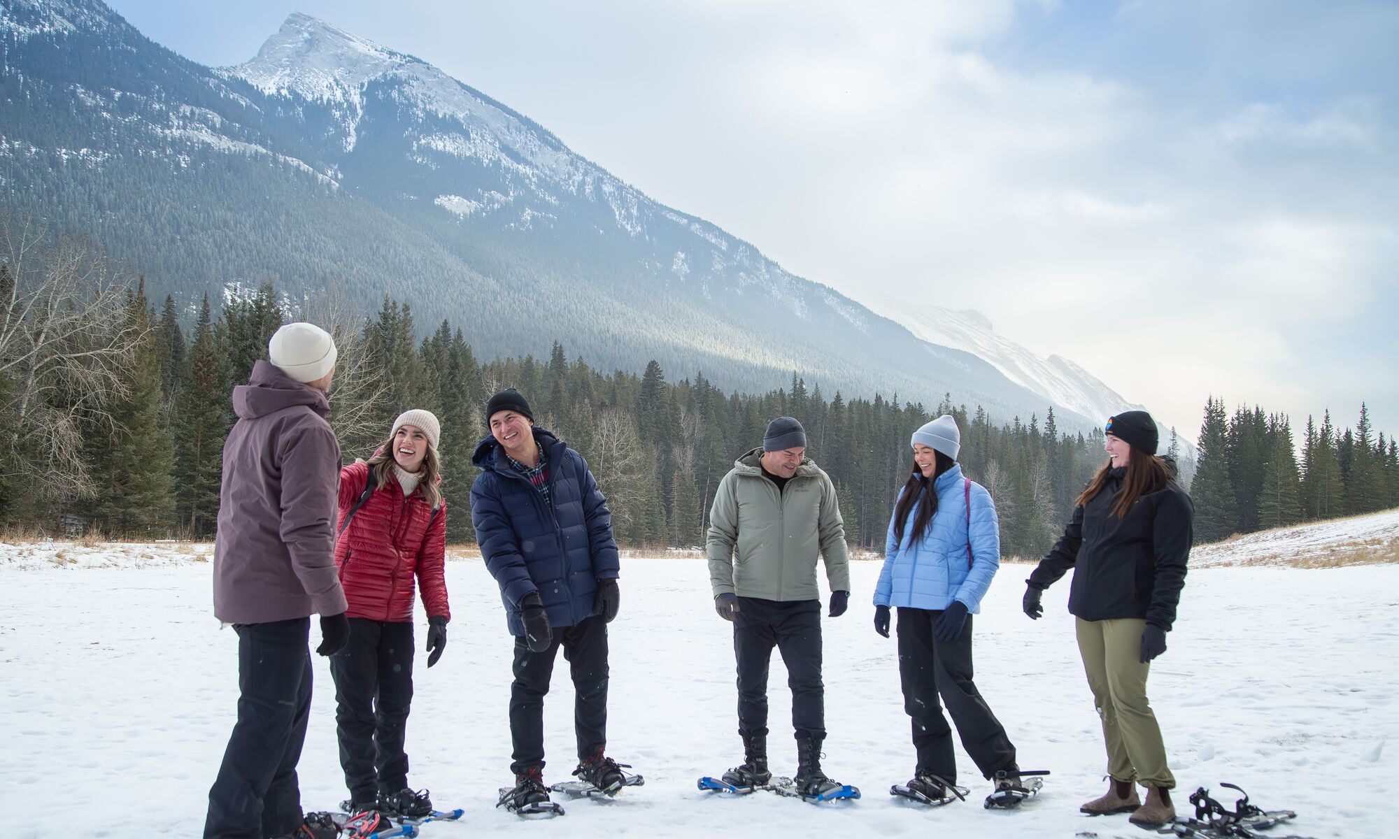 A group of 6 people snowshoeing in Banff National Park