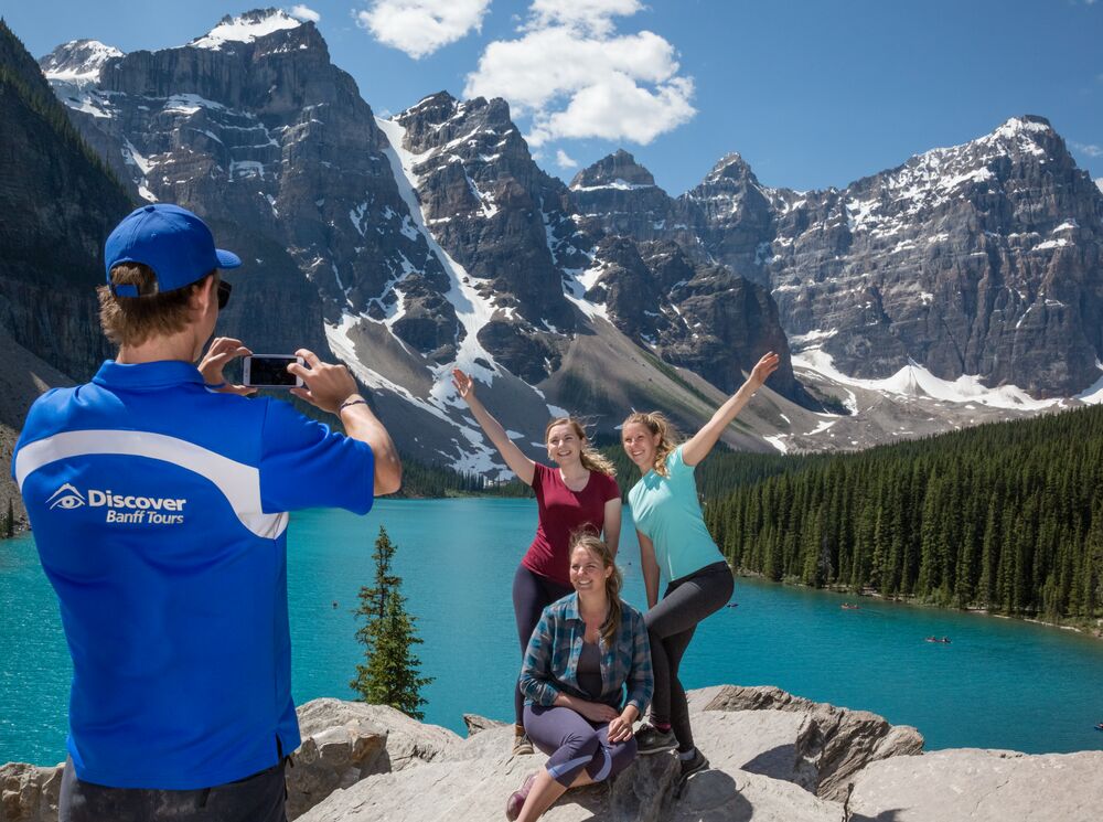 Three people on a guided tour at Moraine Lake in Banff National Park