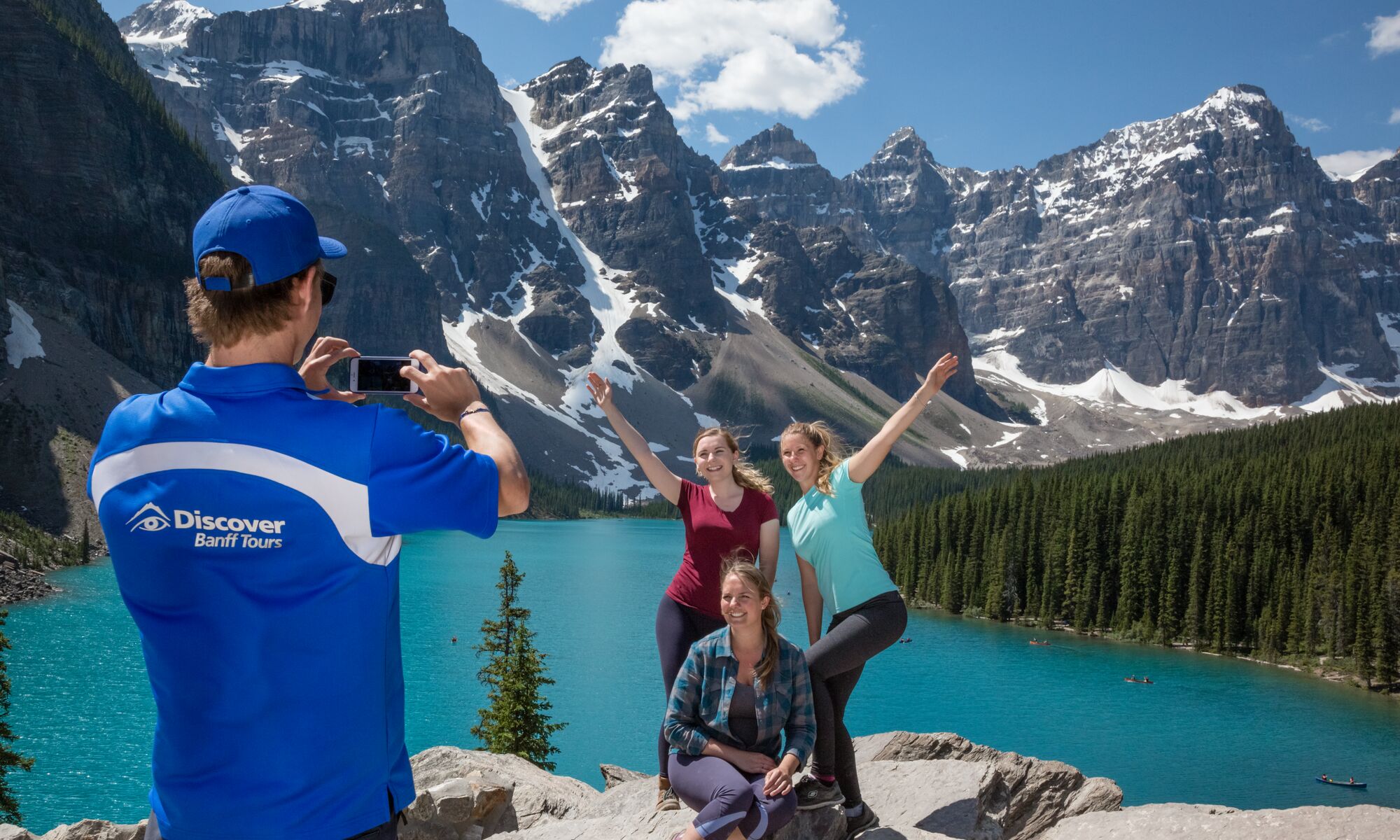 Three people on a guided tour at Moraine Lake in Banff National Park
