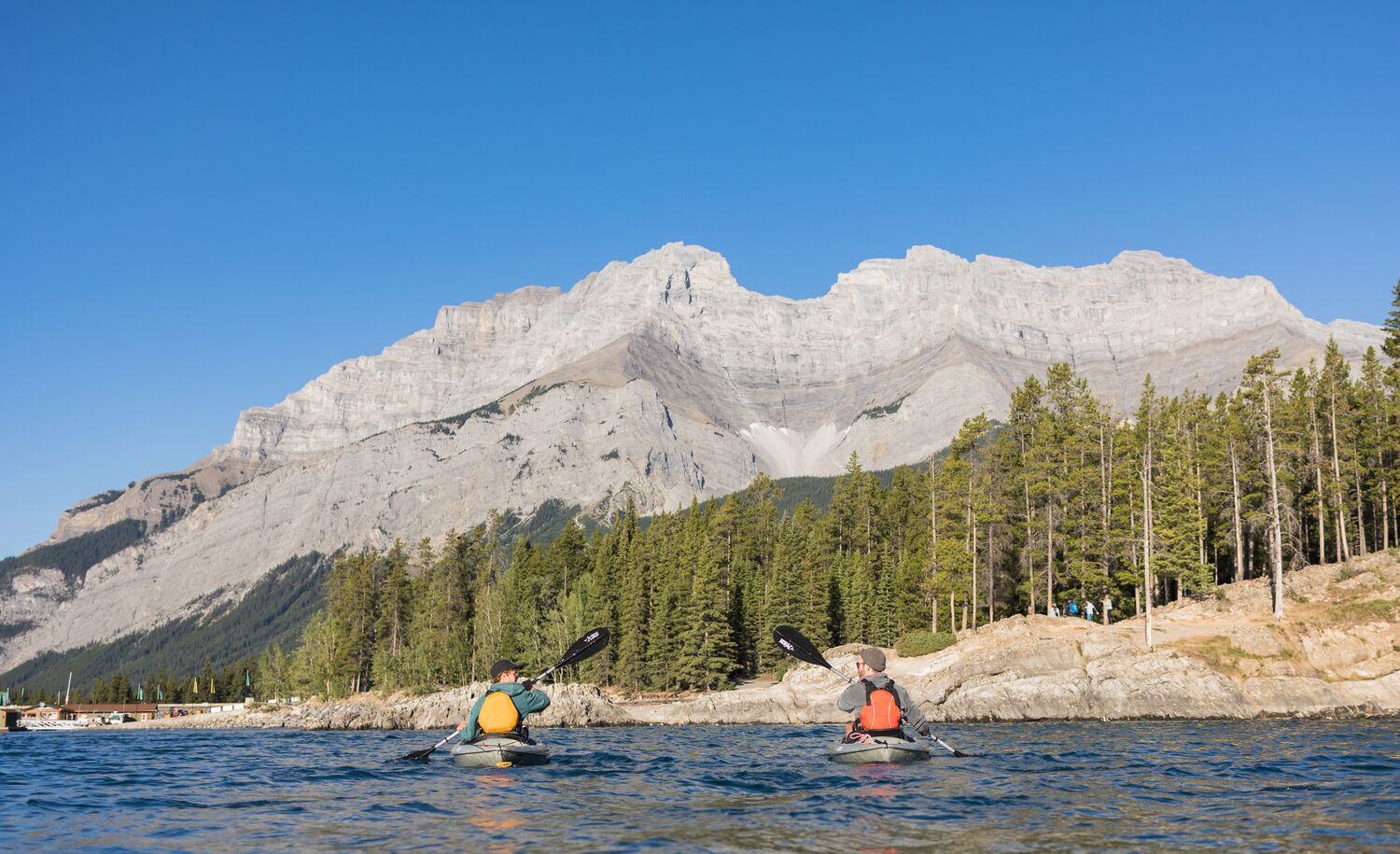 Two people kayaking on Lake Minnewanka in Banff National Park
