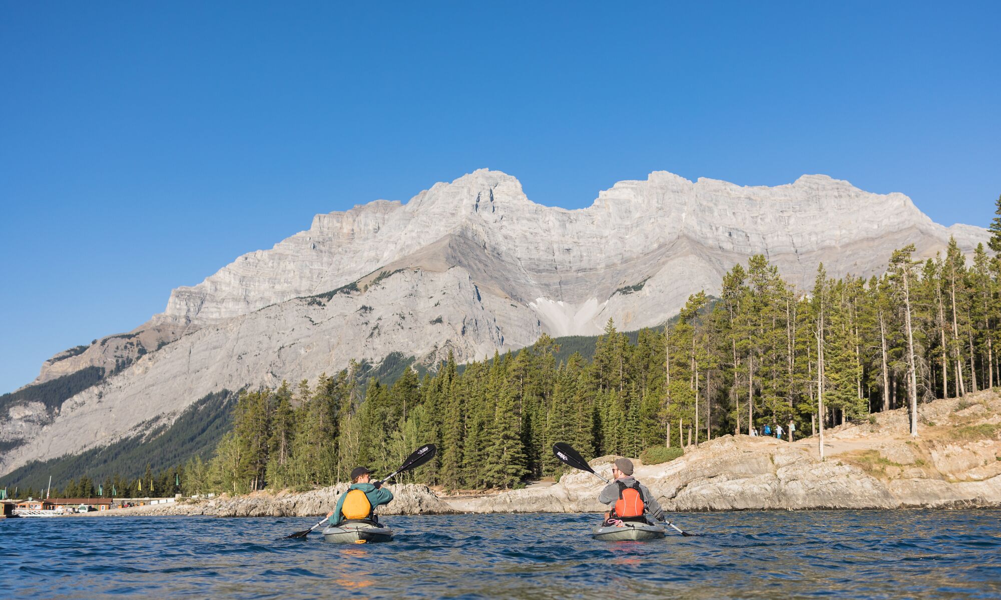 Two people kayaking on Lake Minnewanka in Banff National Park