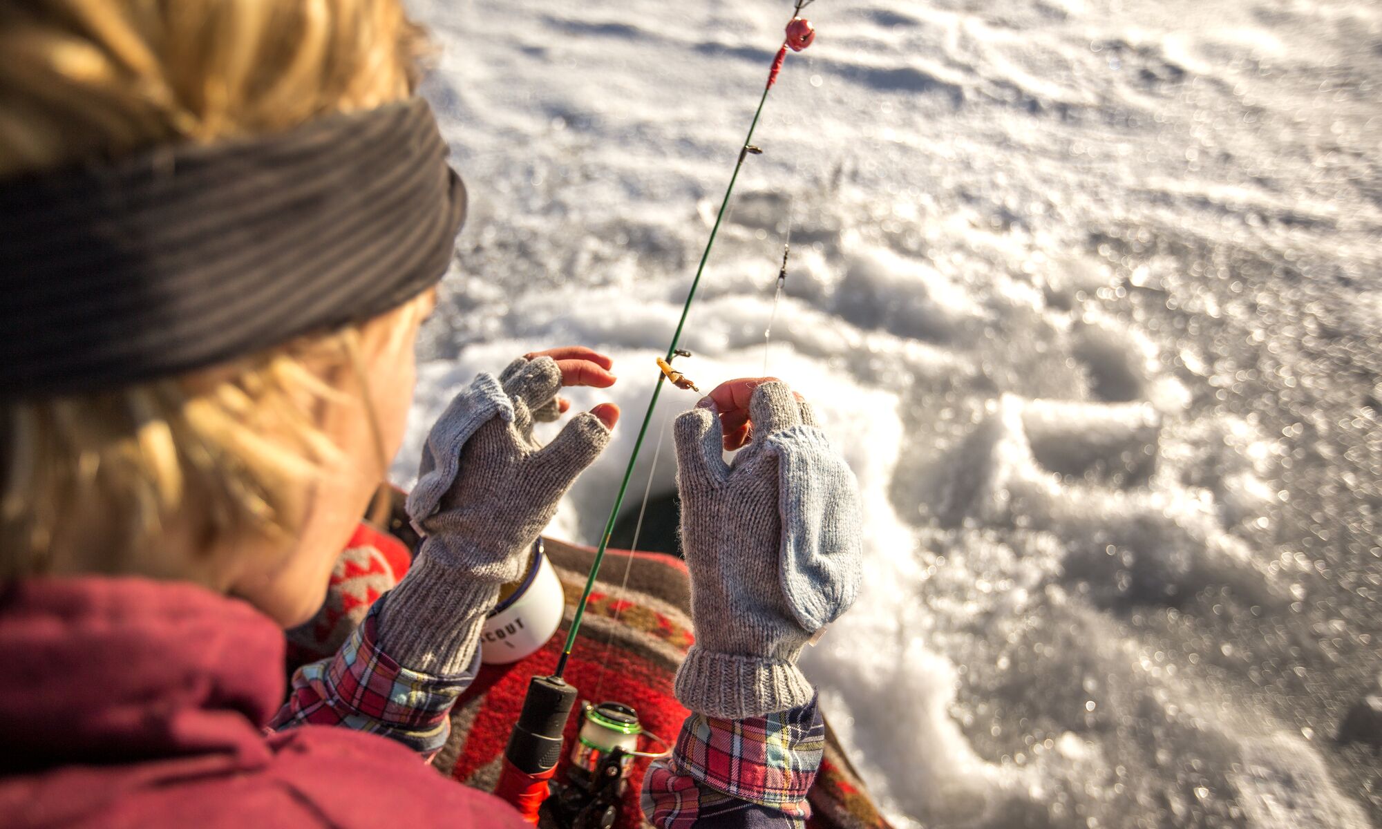 A person ice fishing in Banff National Park