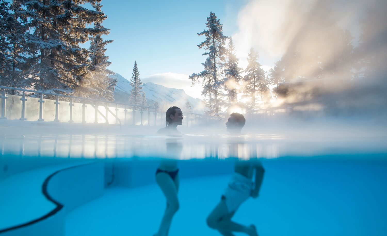 A couple swims in the Banff Upper Hot Springs in Banff, Canada.