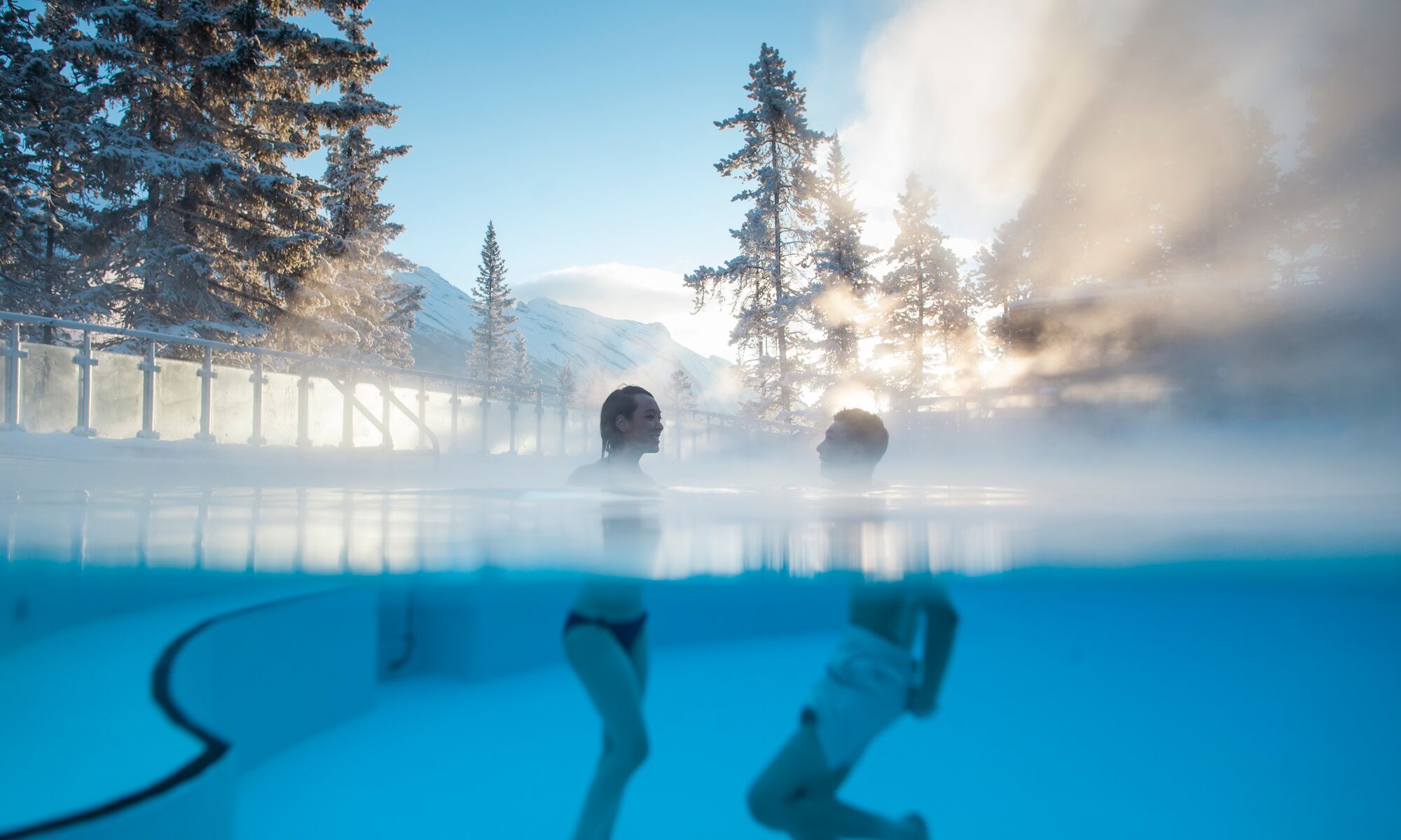 A couple swims in the Banff Upper Hot Springs in Banff, Canada.