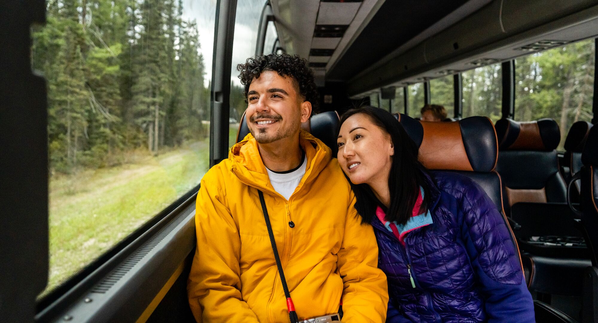 A couple riding the shuttle bus to Moraine Lake or Lake Louise