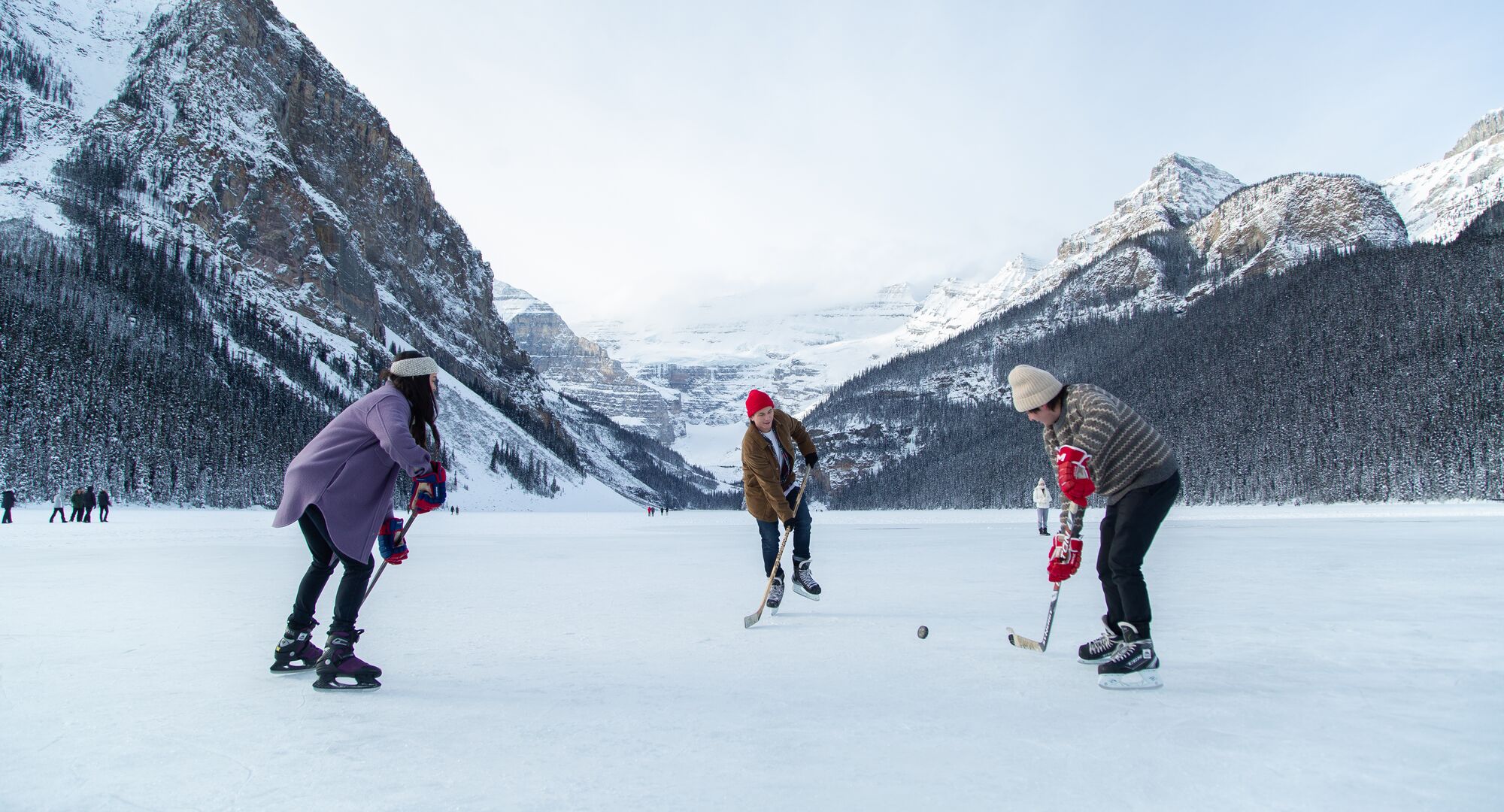 A group of friends playing hockey on Lake Louise in Banff National Park