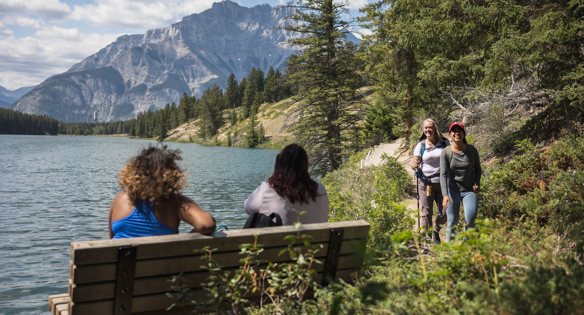 Group of friends hiking the lakeshore at Johnson Lake in the summer