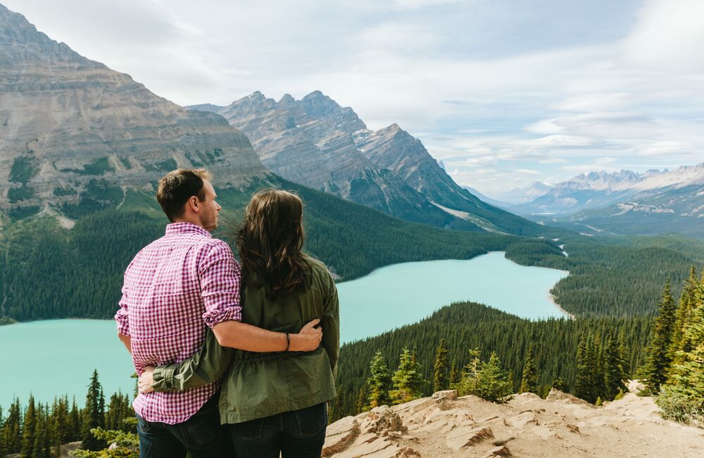Two people taking in the view of Peyto Lake in the summer time