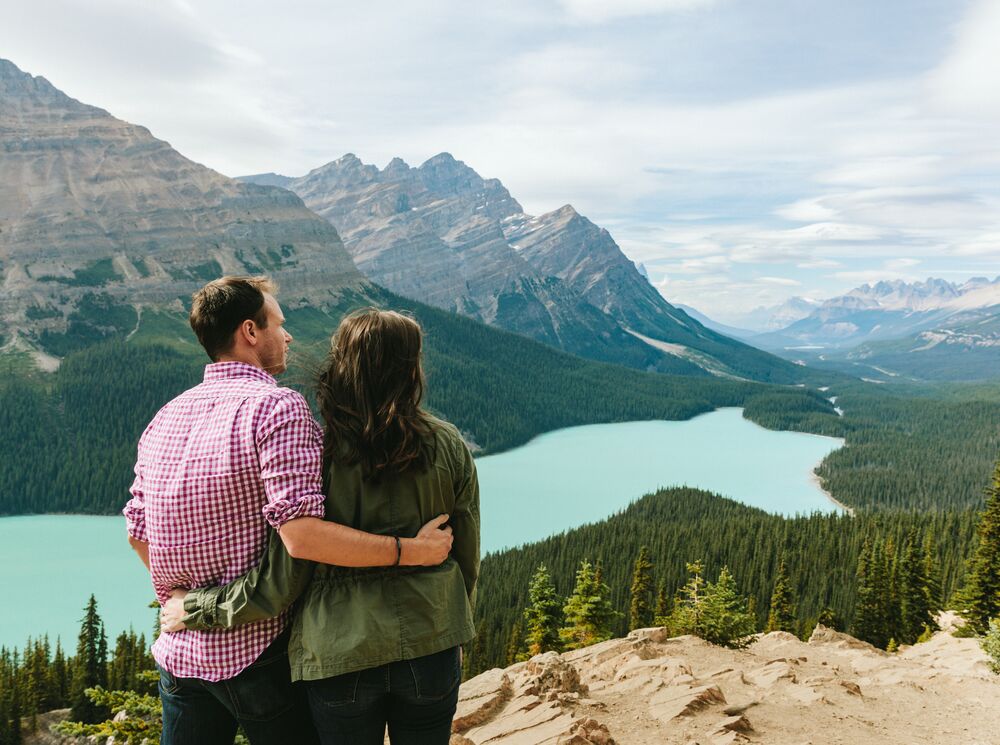 Two people taking in the view of Peyto Lake in the summer time