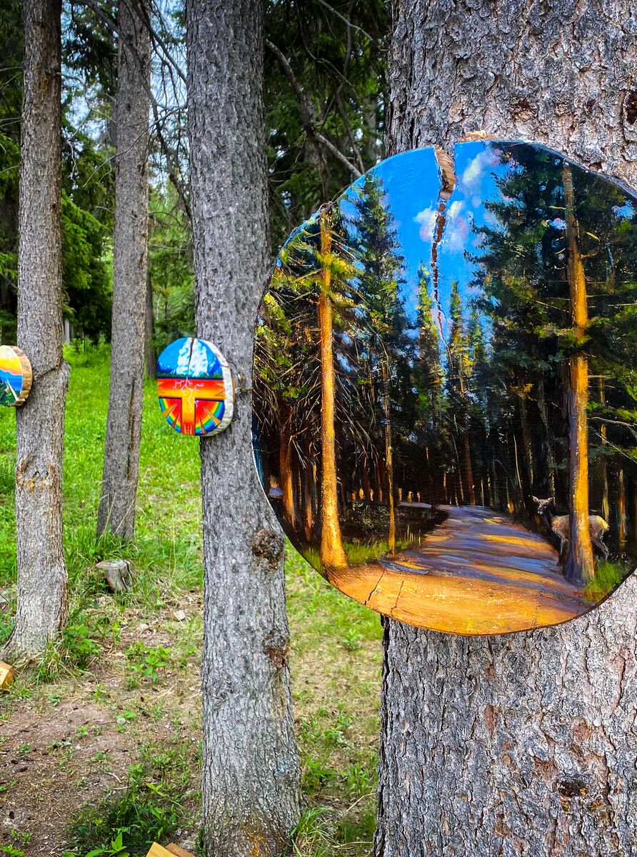 Paintings hang on trees during the Art in Nature Trail in Banff.