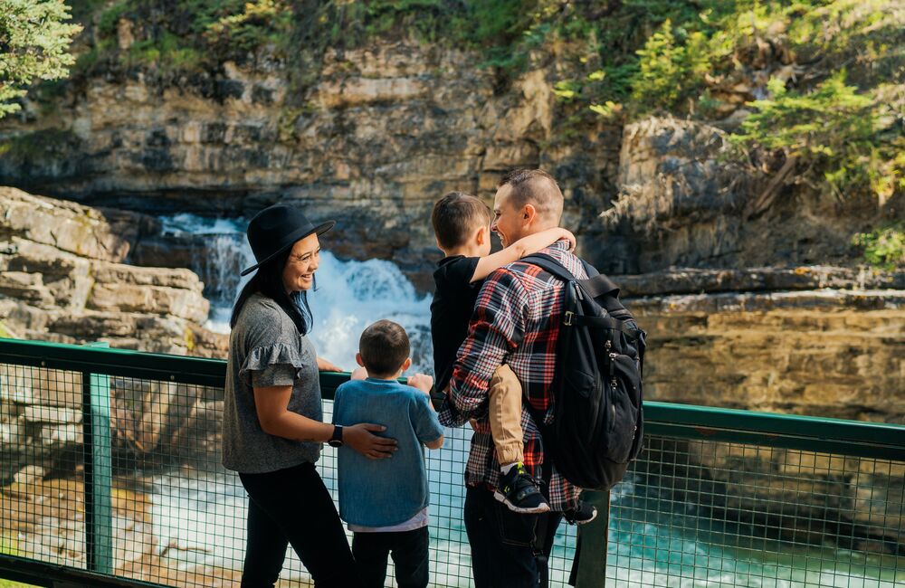 Hikers The sweet couple and their children are enjoying the place of Johnston Canyon.explore Johnston Canyon waterfalls in Banff National Park.