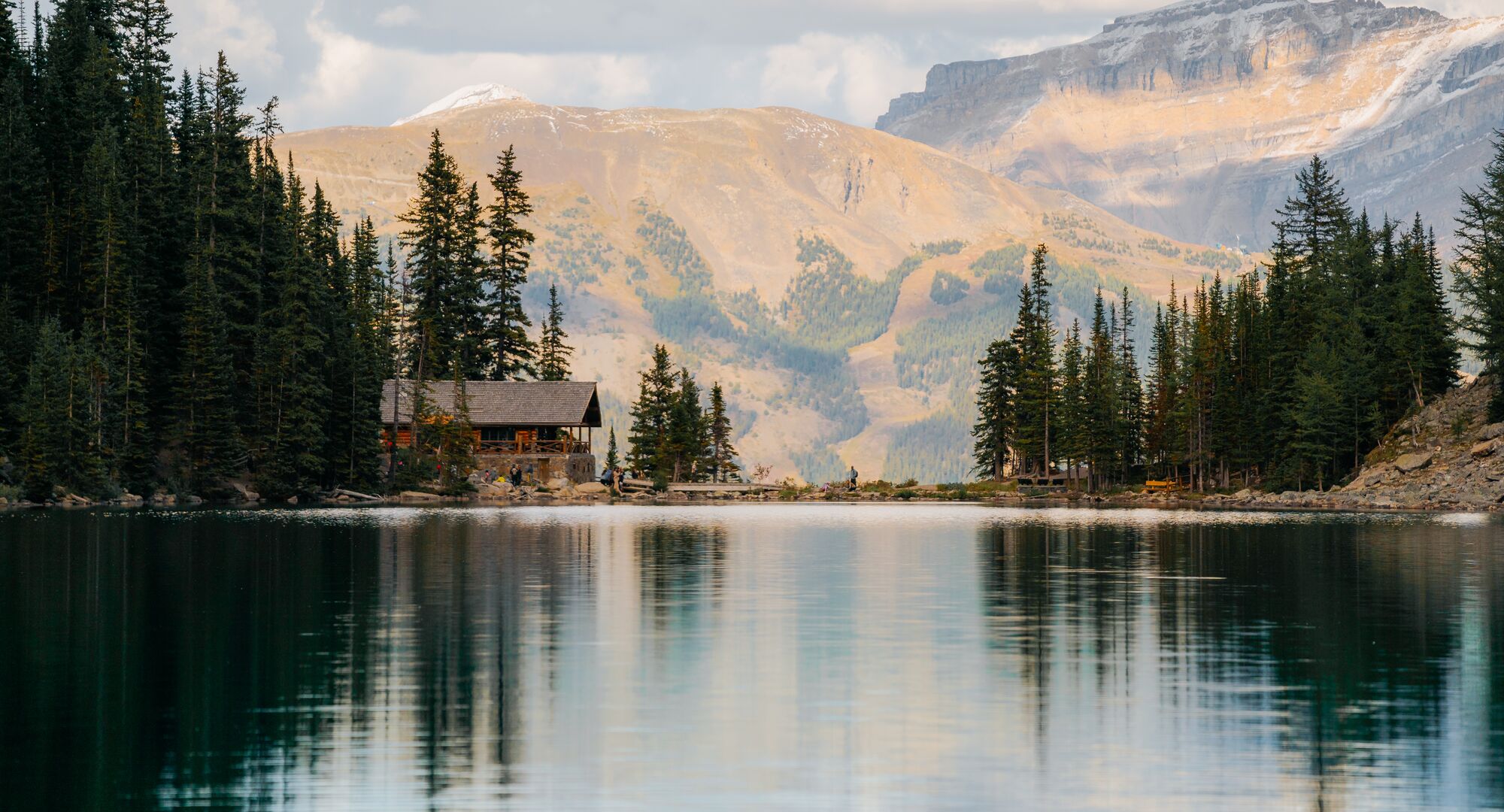 View looking across Lake Agnes to the Lake Agnes Tea House with mountains in the background