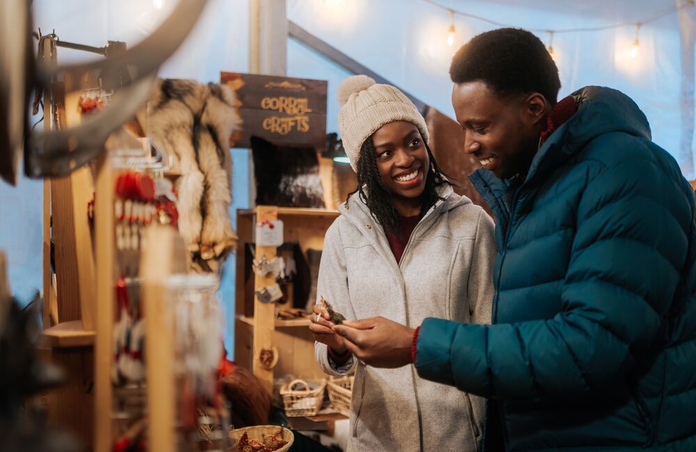 A couple looks at Christmas gifts at the Banff Christmas Market in Banff National Park.