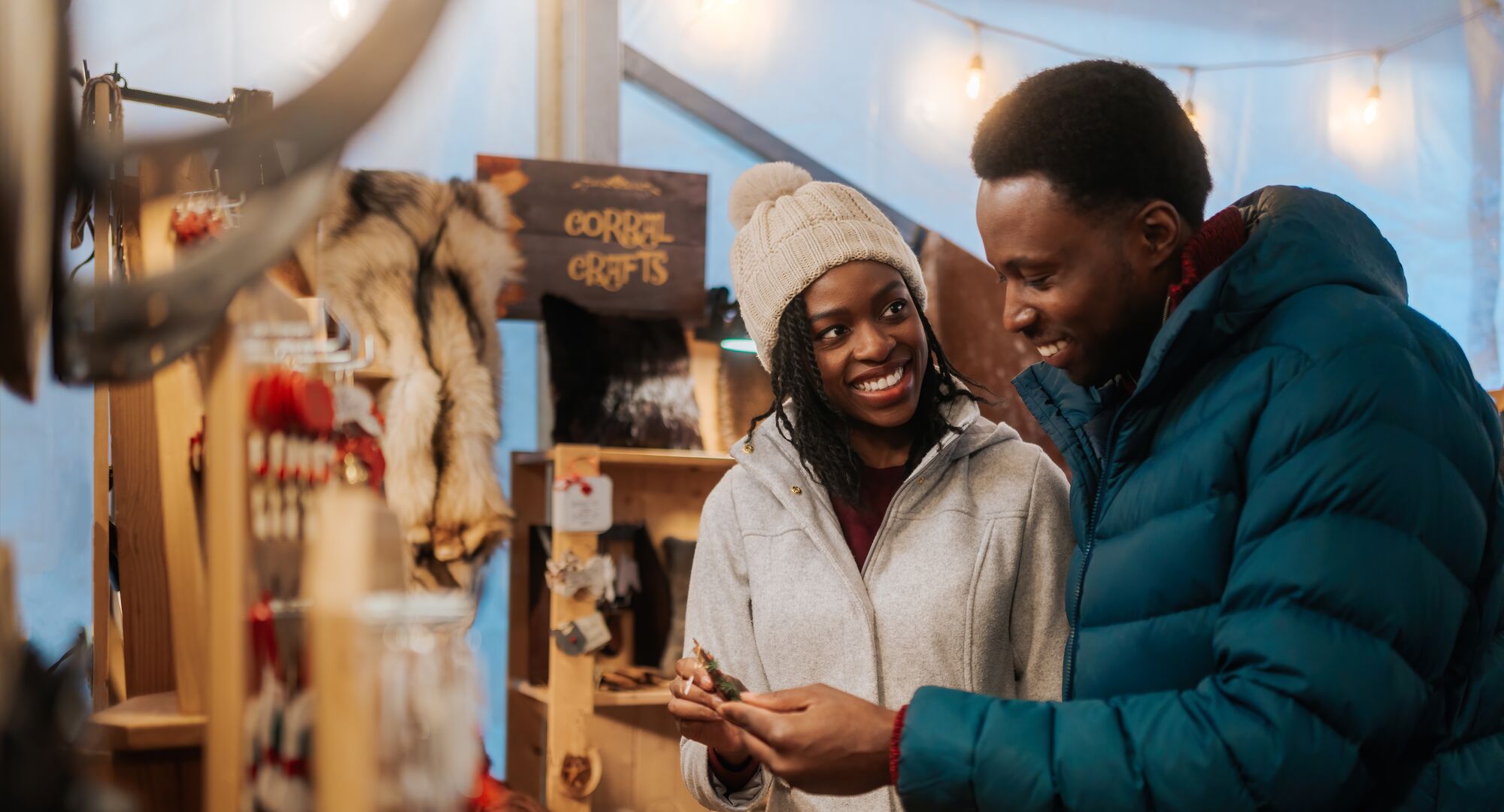 A couple looks at Christmas gifts at the Banff Christmas Market in Banff National Park.