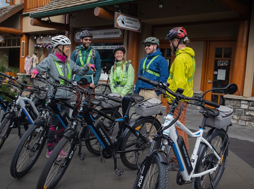 A group waits for a guided e-bike tour to start in Banff National Park.