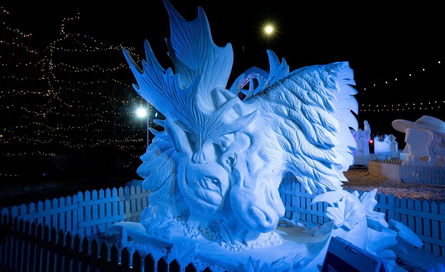 Large snow sculpture of two moose heads on Bear Street in Banff during Snowdays