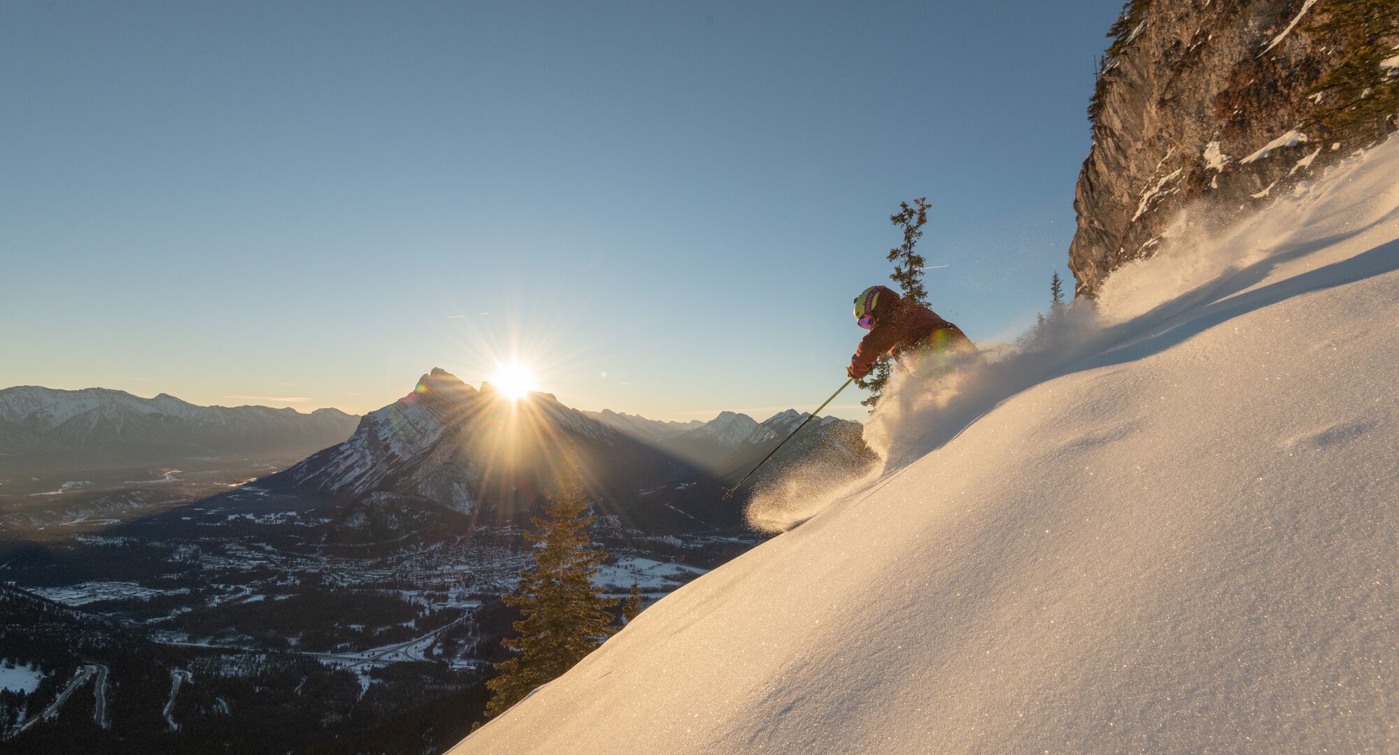 Person skiing powder in the backcountry in Banff National Park