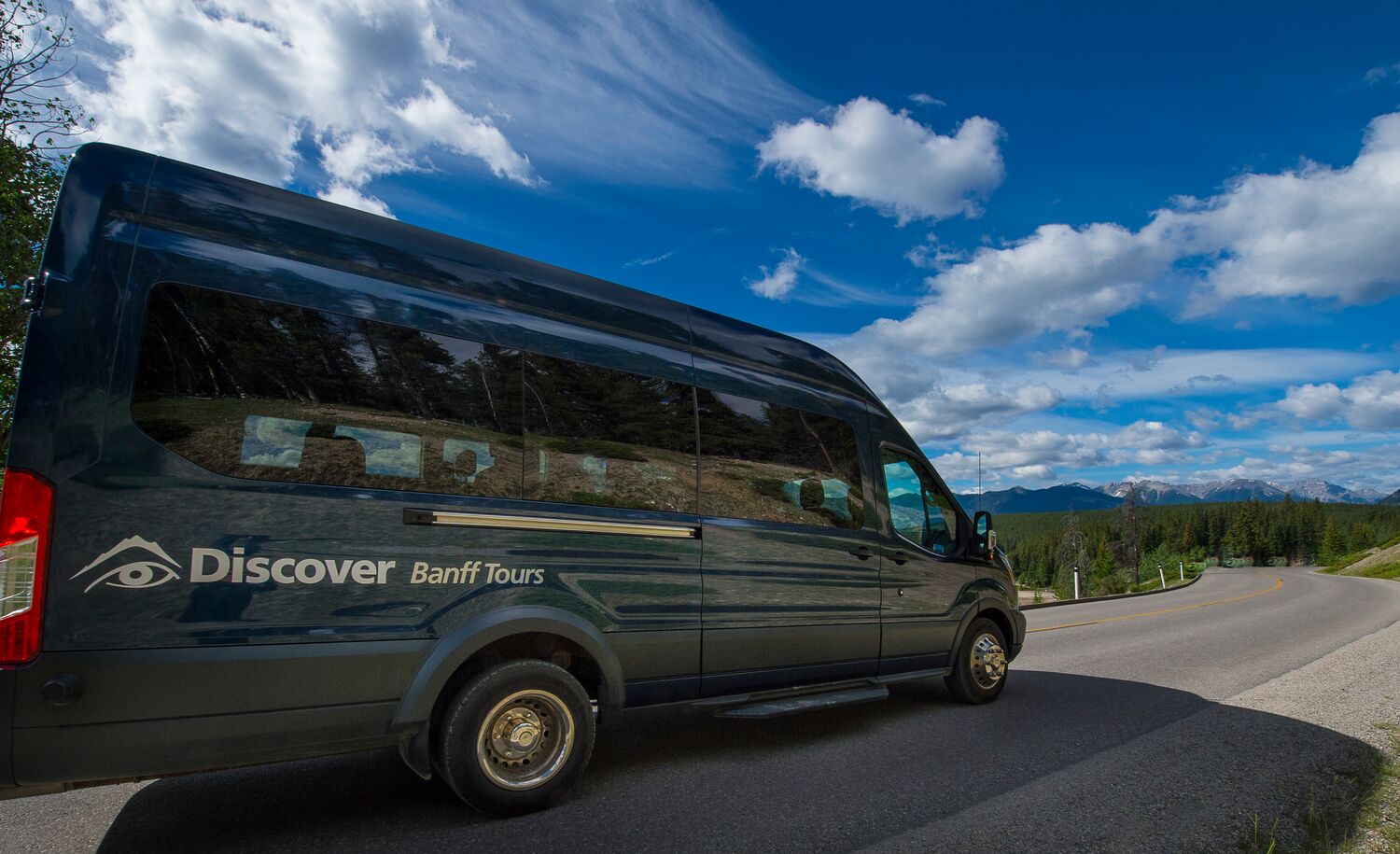 Discover Banff Tours bus on a bluebird day in Banff National Park.