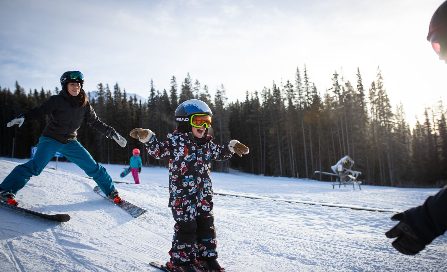 A child learning how to ski with an instructor at Lake Louise ski resort in Banff National Park