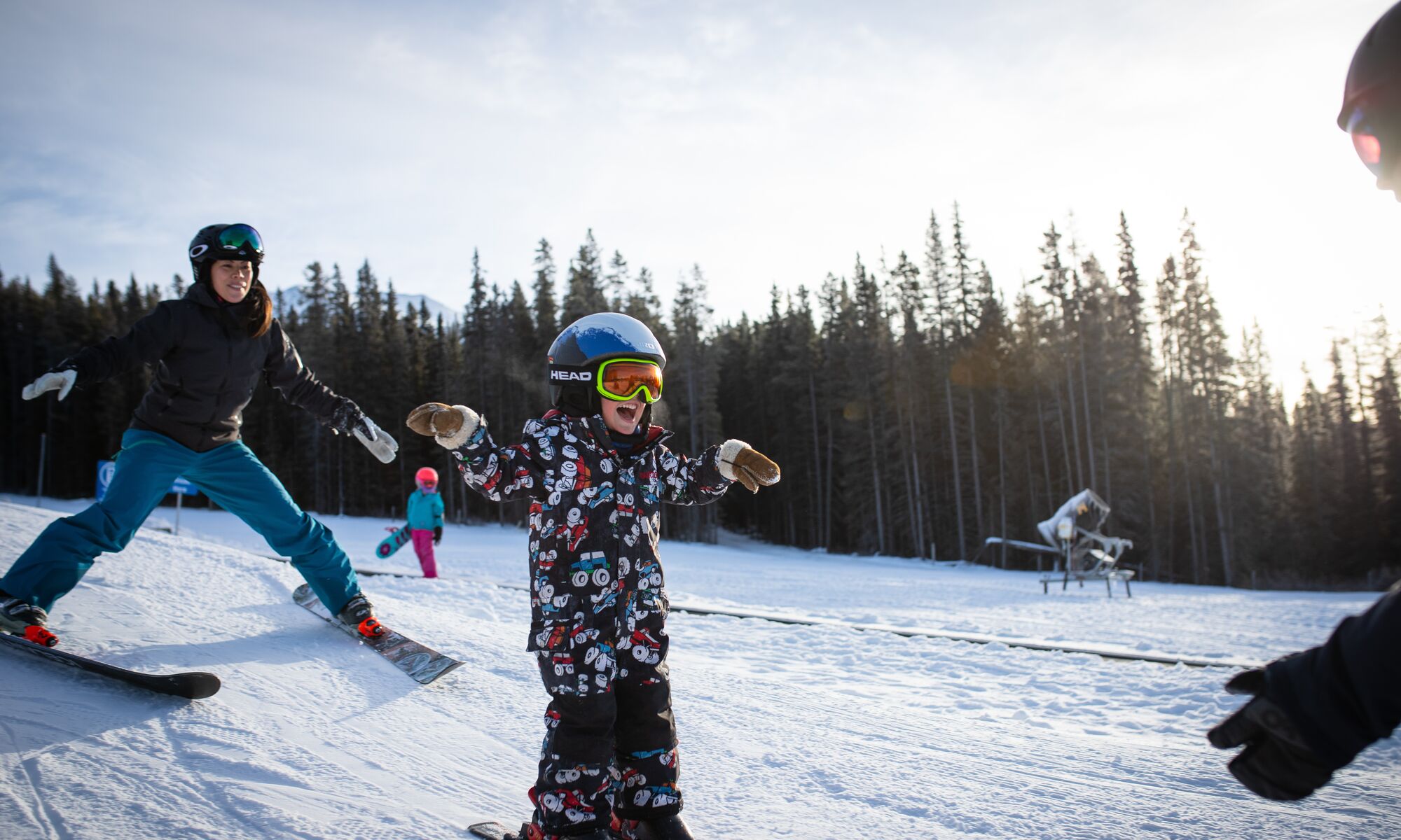 A child learning how to ski with an instructor at Lake Louise ski resort in Banff National Park