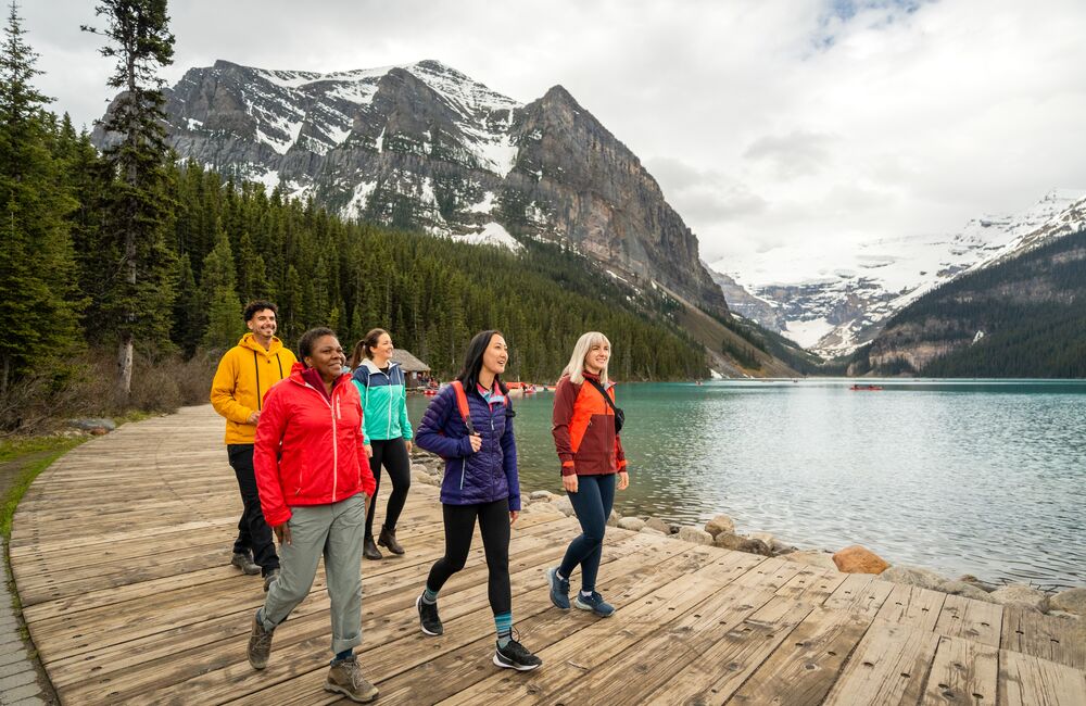 A group of friends exploring the Lake Louise lakeshore