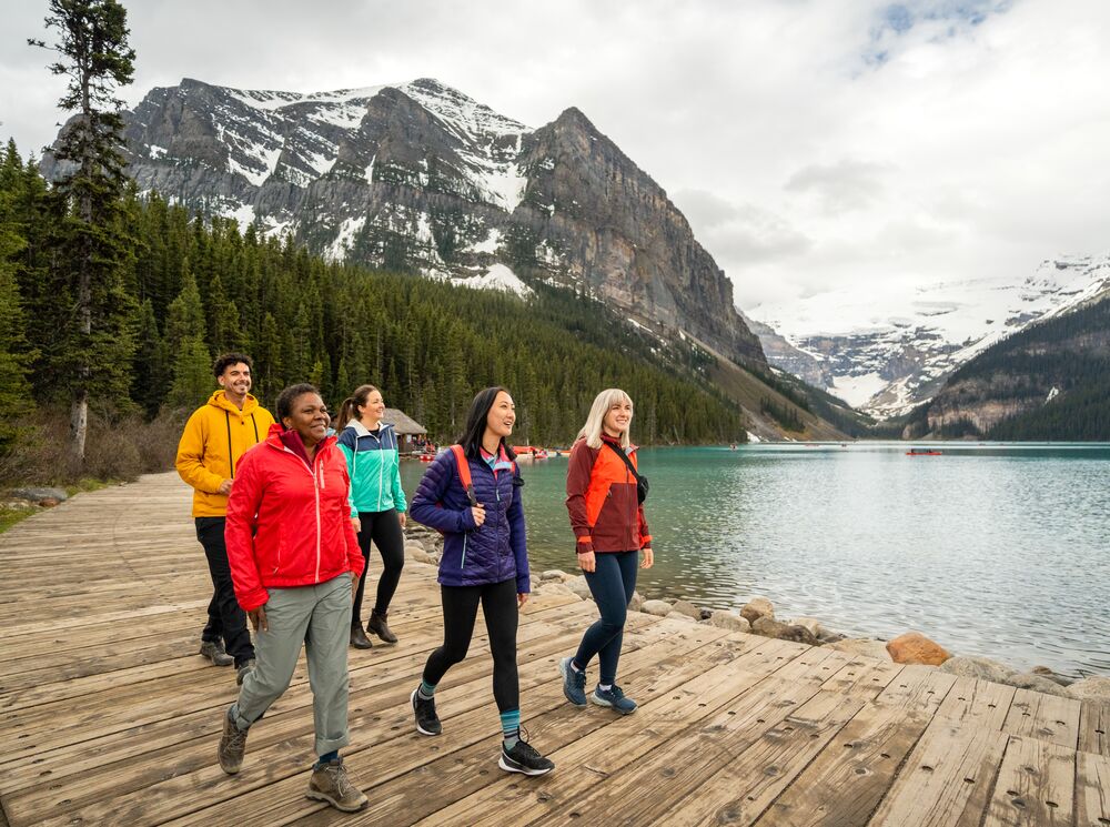 People walk on the shores of Lake Louise in Banff National Park.