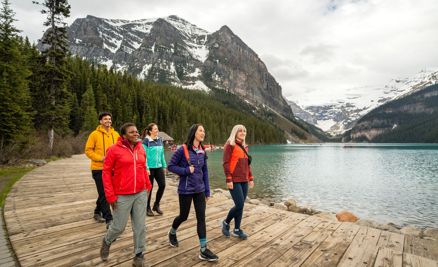 People walk on the shores of Lake Louise in Banff National Park.
