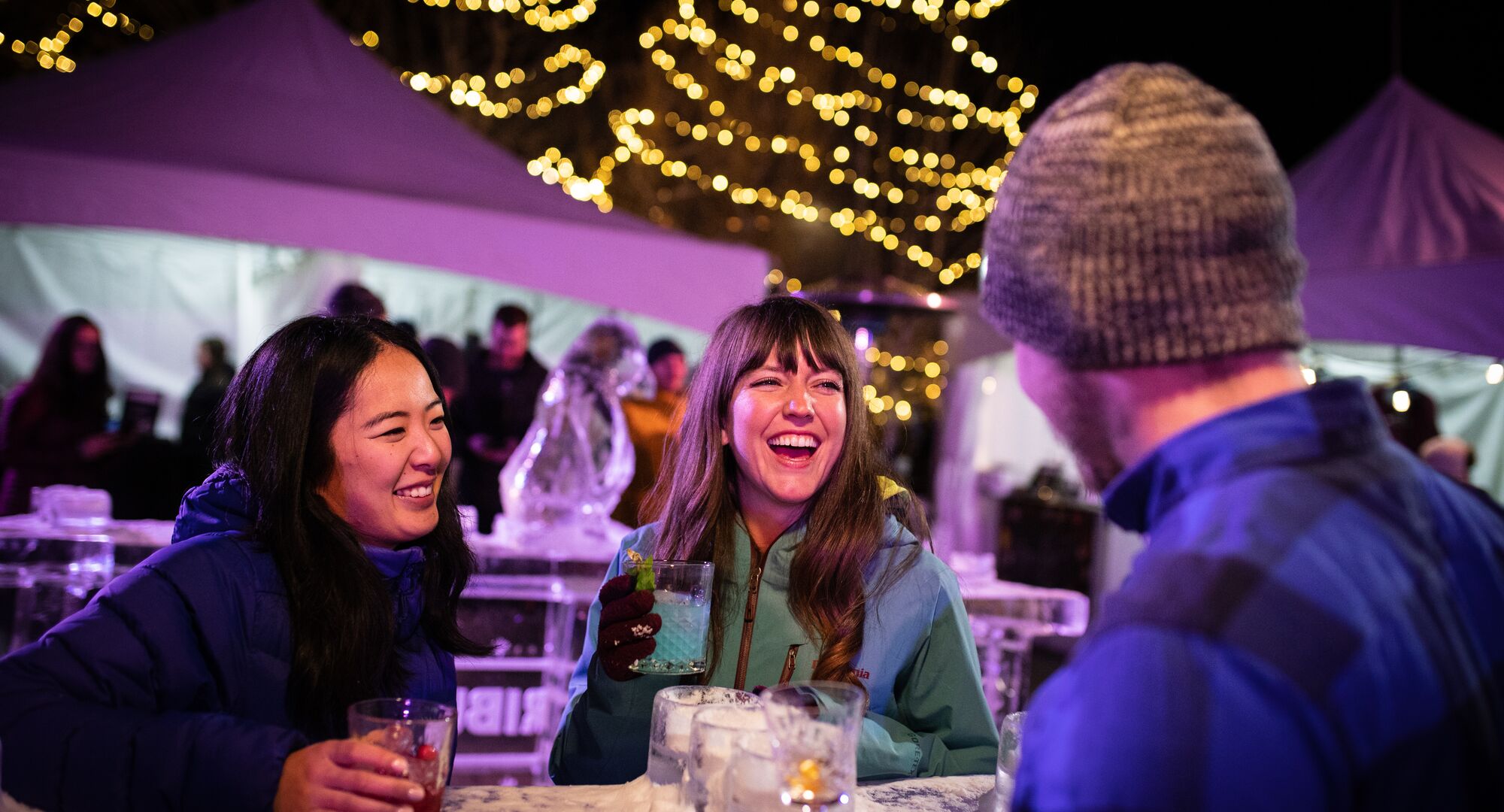 Group of friends enjoying cocktails at an outdoor tasting event on bear Street.