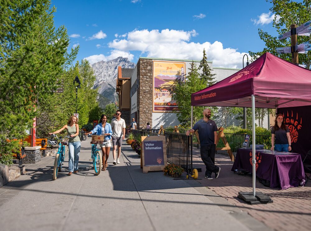 People using the bike parking on Banff Ave, a popular thing to do in Banff in June