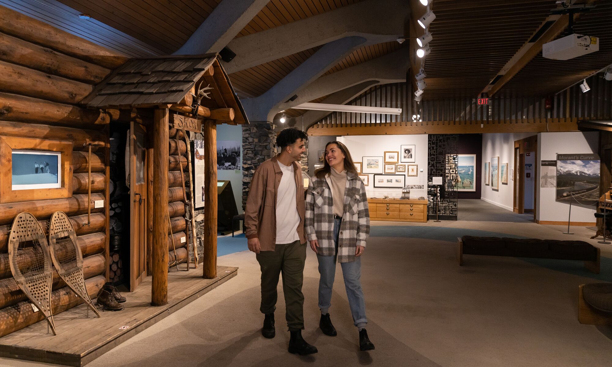 Two people walk through the Whyte Museum of the Canadian Rockies.