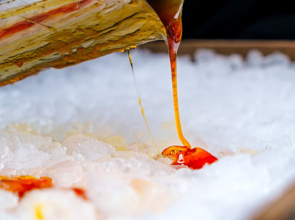 Maple syrup pours over ice at the Fairmont Banff Springs in Banff, Canada.