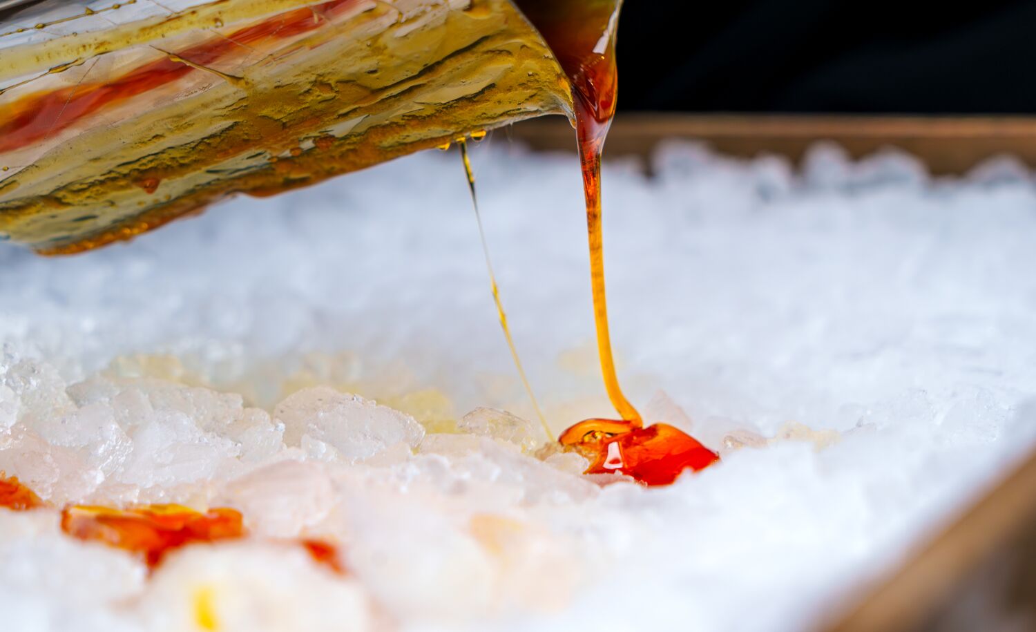 Maple syrup pours over ice at the Fairmont Banff Springs in Banff, Canada.