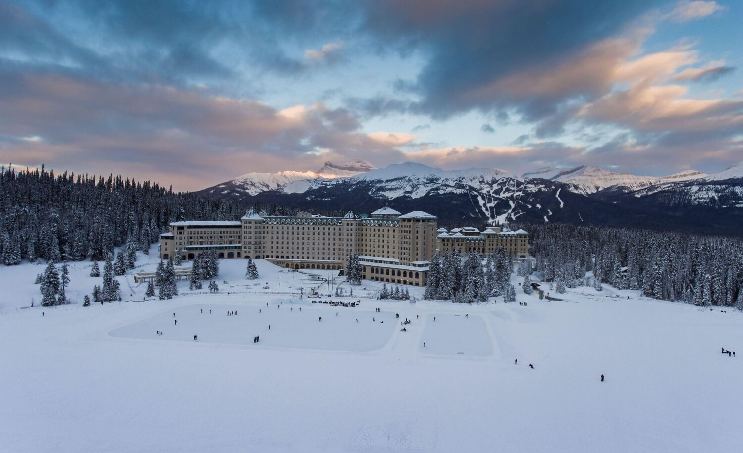 The Fairmont Chateau Lake Louise and its outdoor ice rink in the winter.