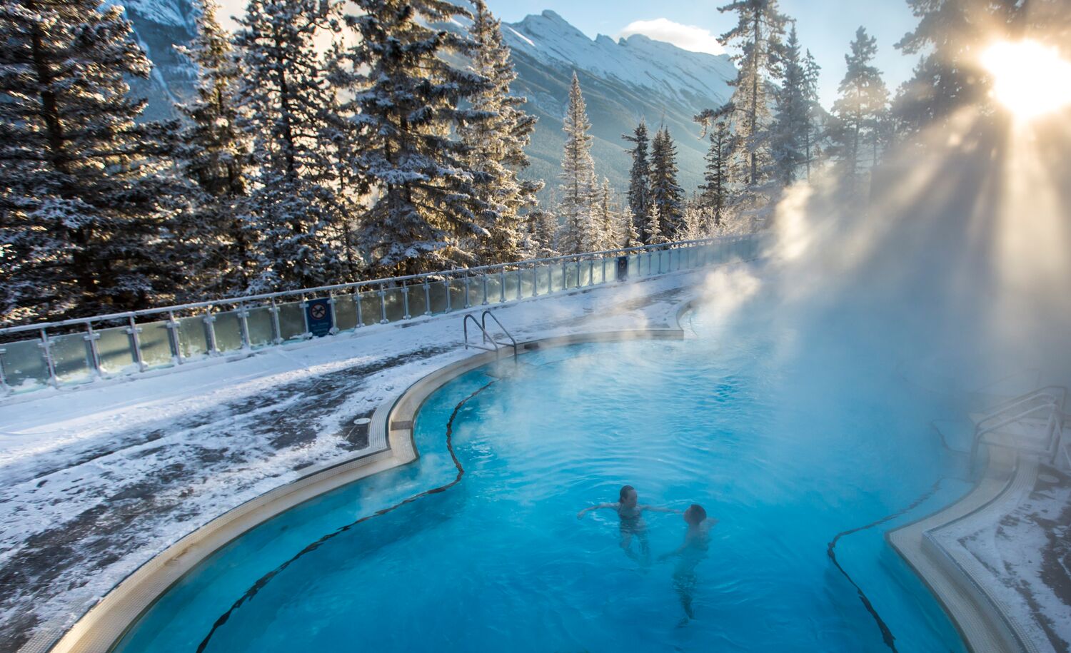 A couple sits in the Upper Hot Springs in Banff National Park on a frosty winter day
