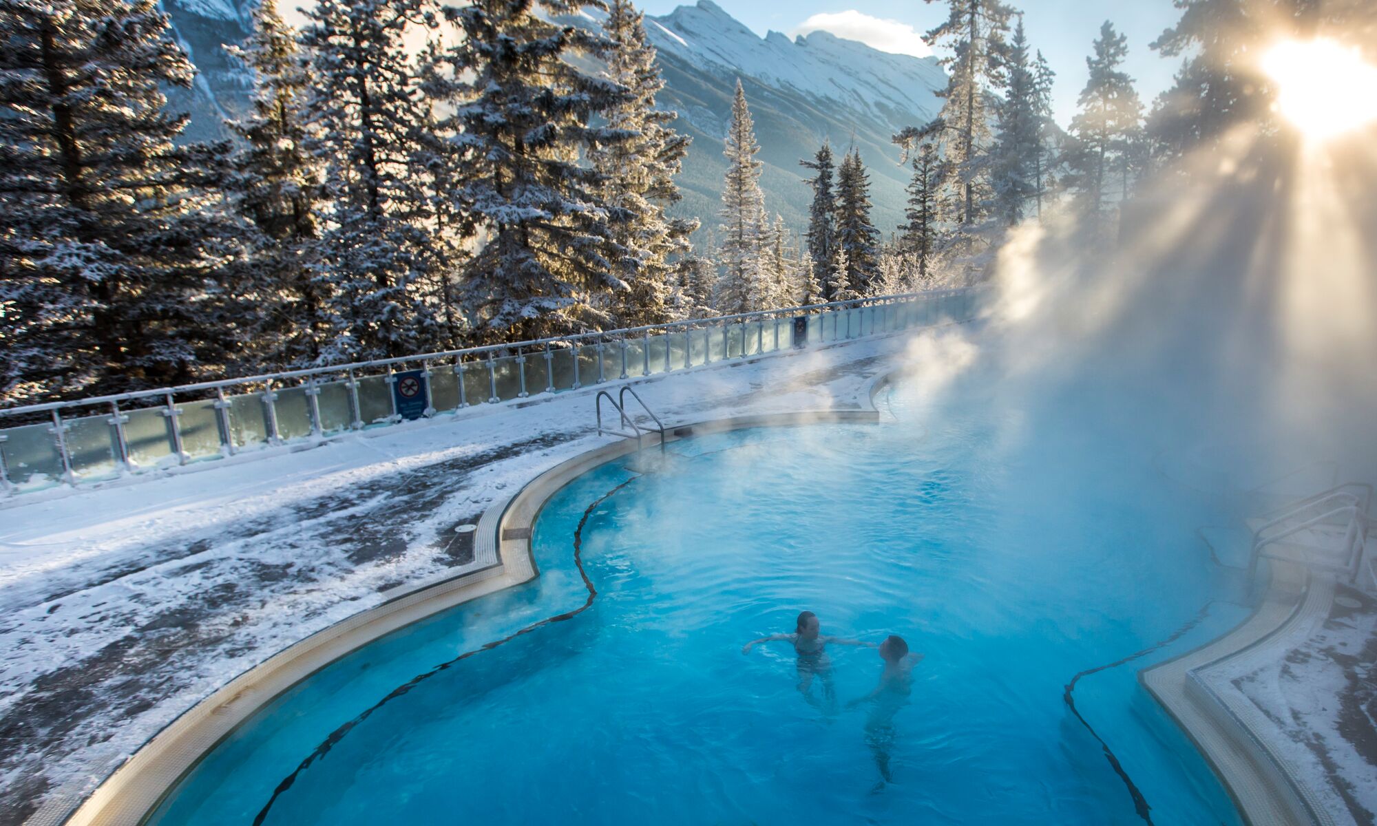 A couple sits in the Upper Hot Springs in Banff National Park on a frosty winter day