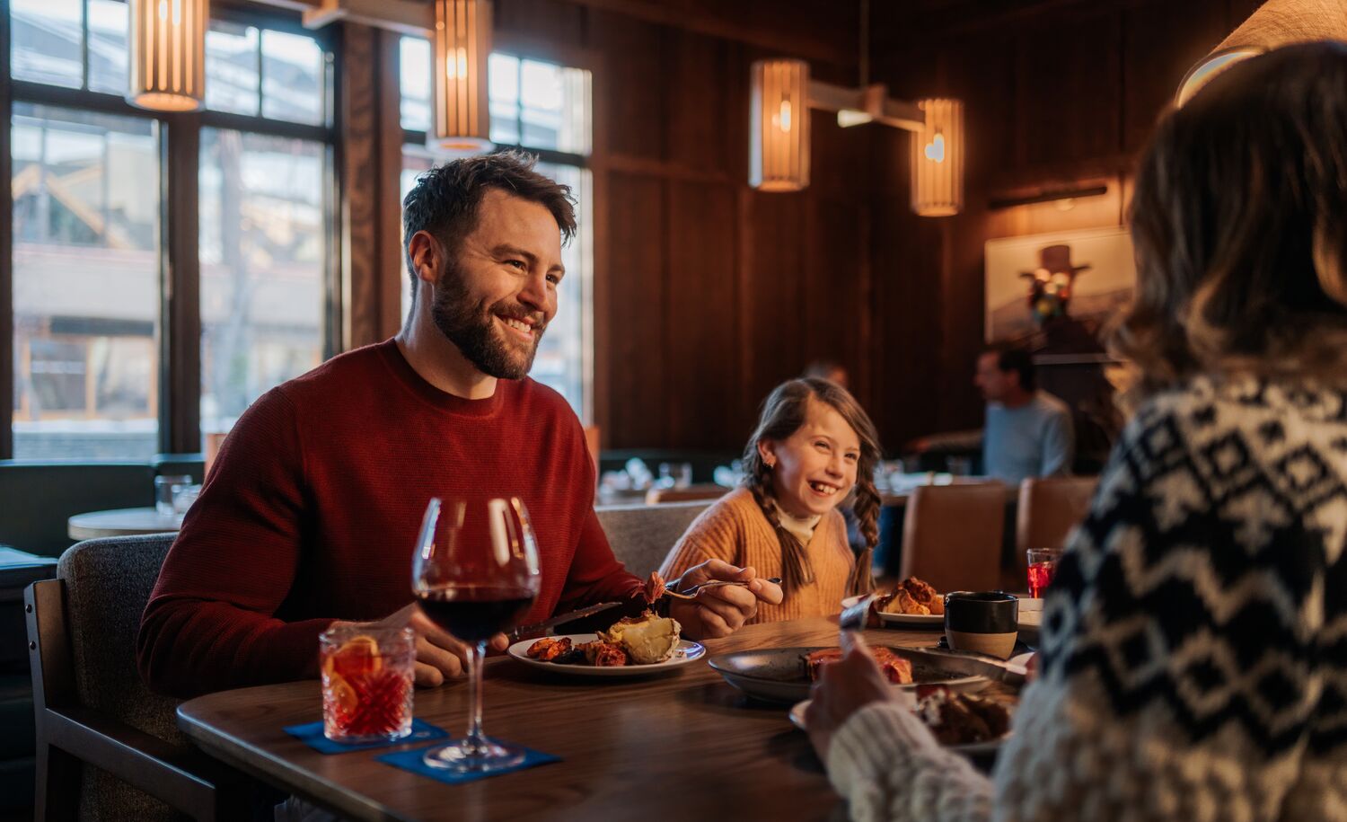 A family enjoys a meal at Bluebird in Banff National Park.