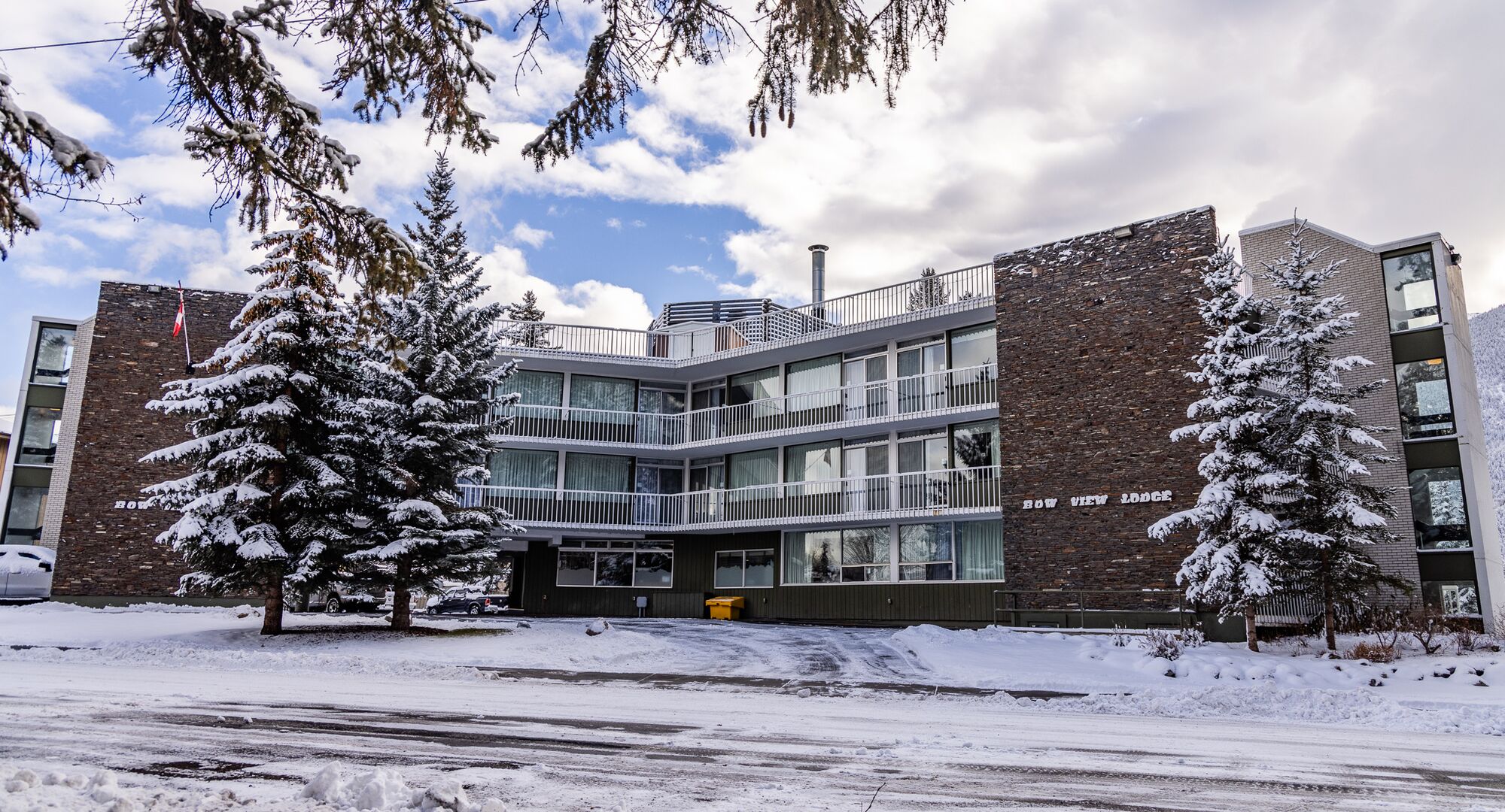 Bow View Lodge blanketed in snow, offering a serene winter experience in the heart of Banff, Alberta.