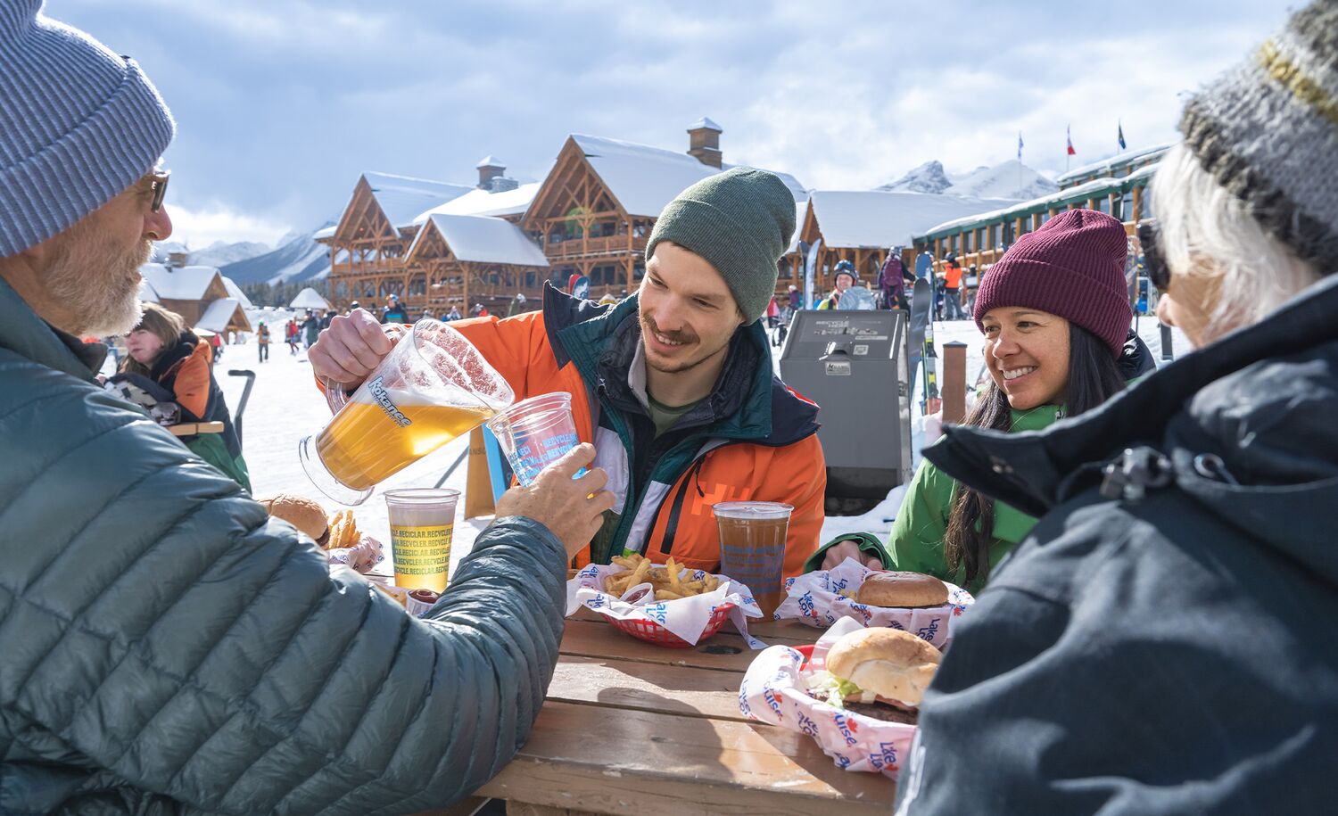 Two Couples having a drink on a patio at the Lake Louise Ski Resort in Banff National Park