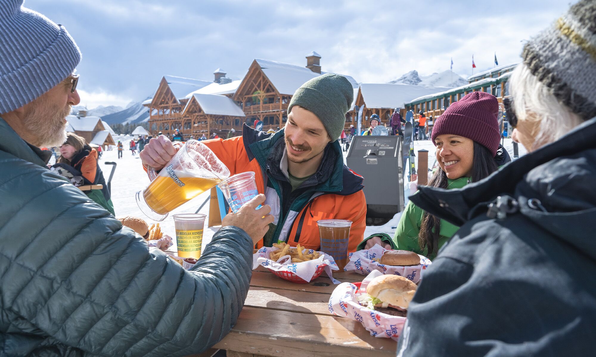 Two Couples having a drink on a patio at the Lake Louise Ski Resort in Banff National Park