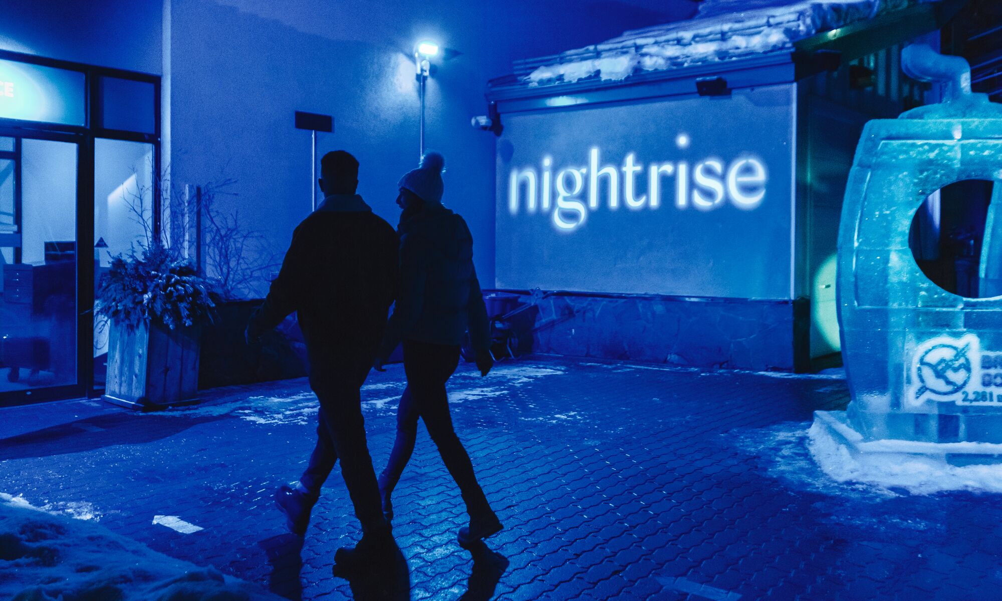 A couple explores the Nightrise Event held at the Banff Gondola in Banff National Park