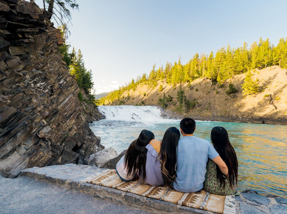 A family takes in Bow Falls in Banff National Park.