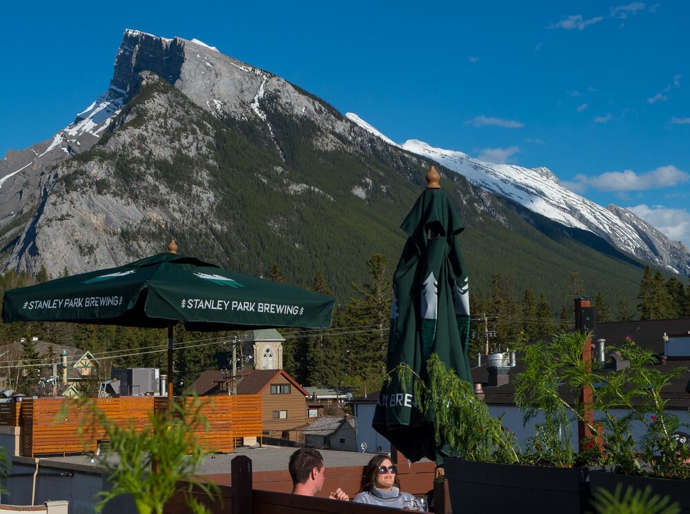 Mount Rundle in the background with the Elk & Oarsman patio in the foreground.
