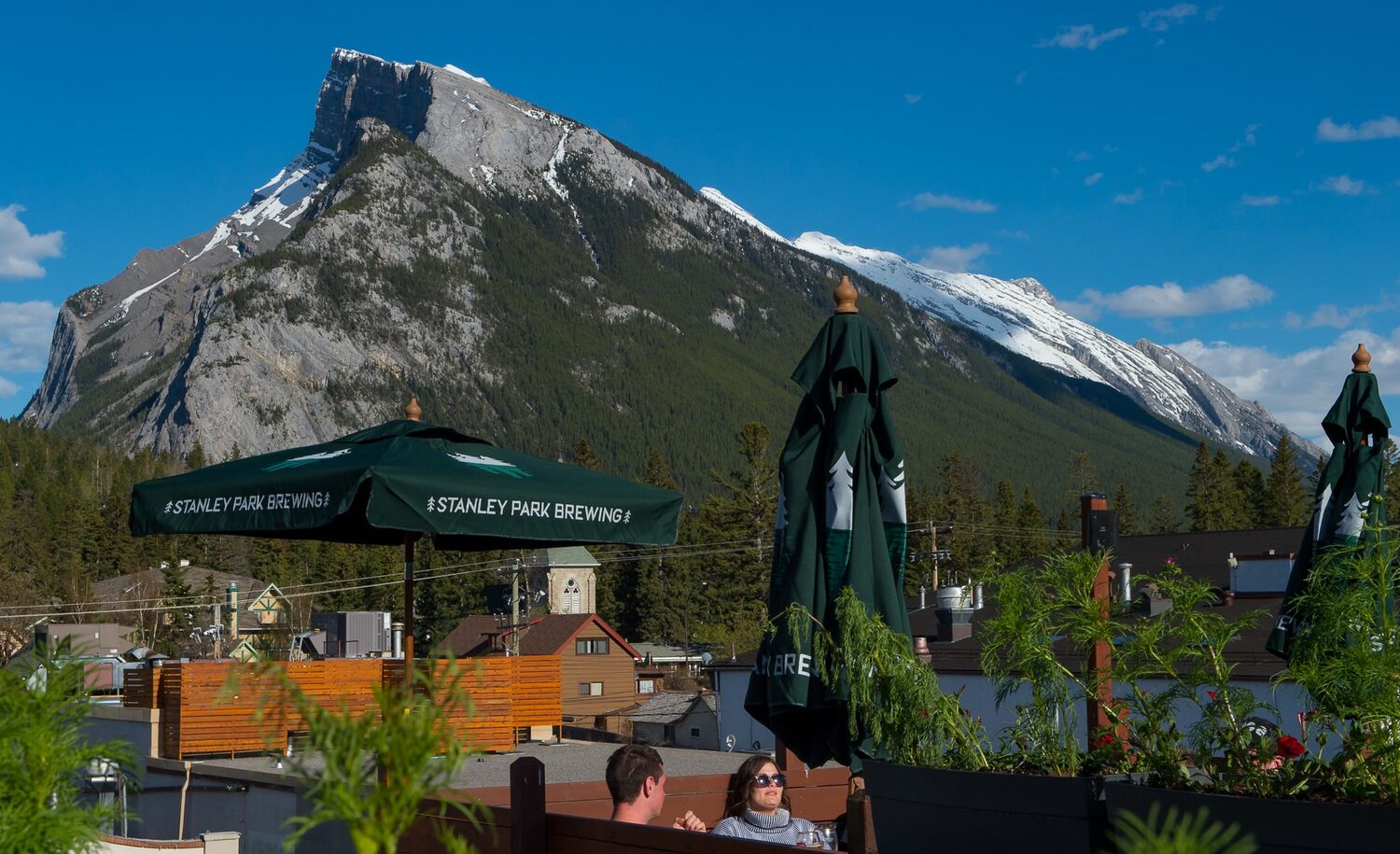 Mount Rundle in the background with the Elk & Oarsman patio in the foreground.