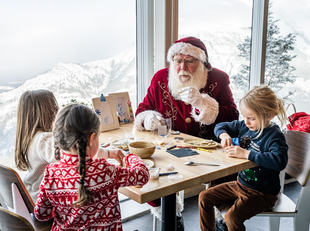 Santa makes crafts with kids at Mountaintop Christmas at the Banff Gondola in Banff National Park.