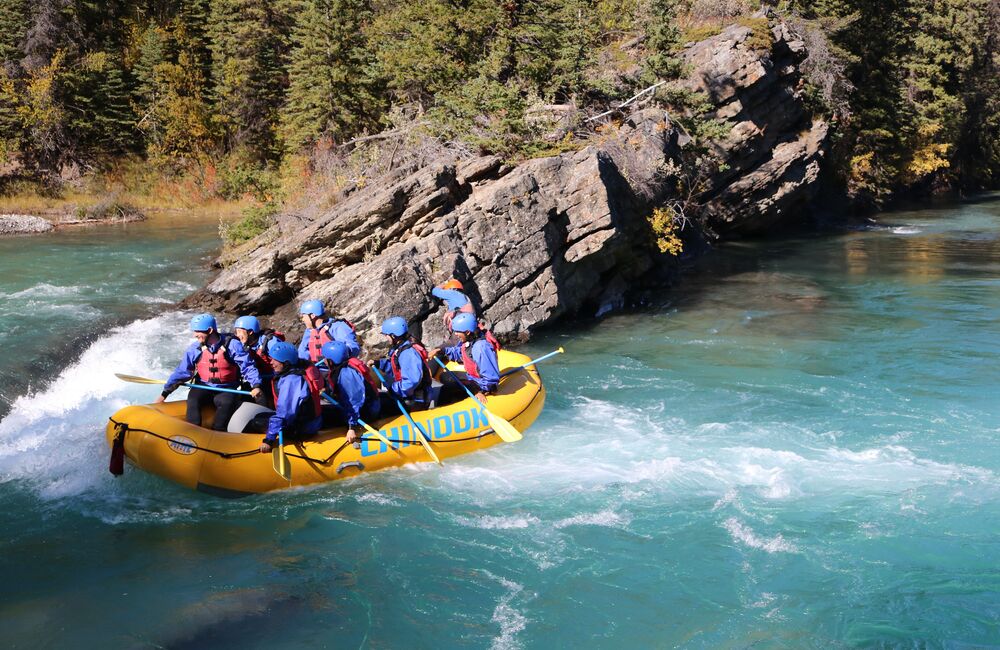 Group of people white water rafting in the Canadian Rockies