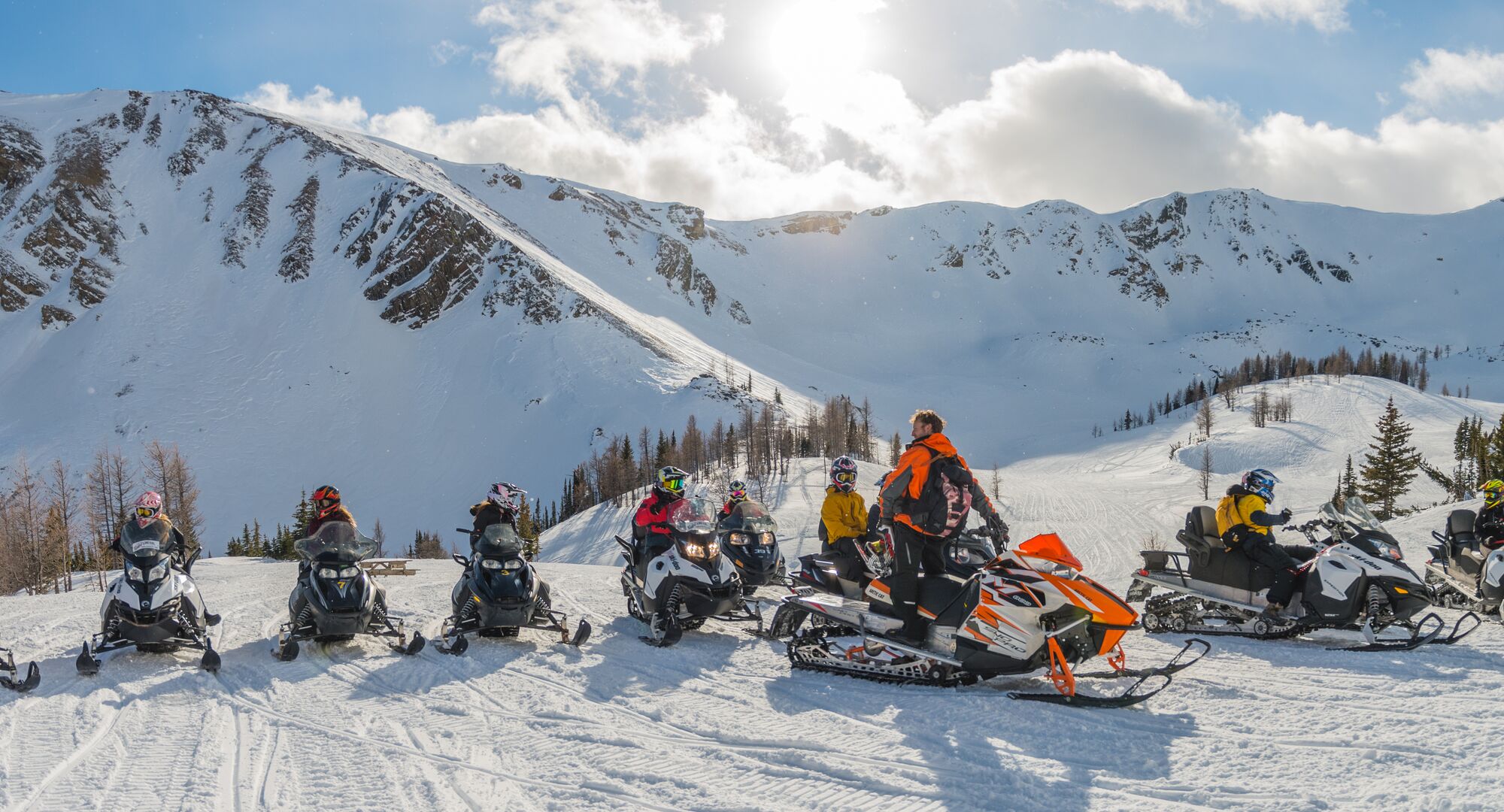 A group of people on a snowmobiling tour in the Canadian Rockies with Toby Creek Advnetures