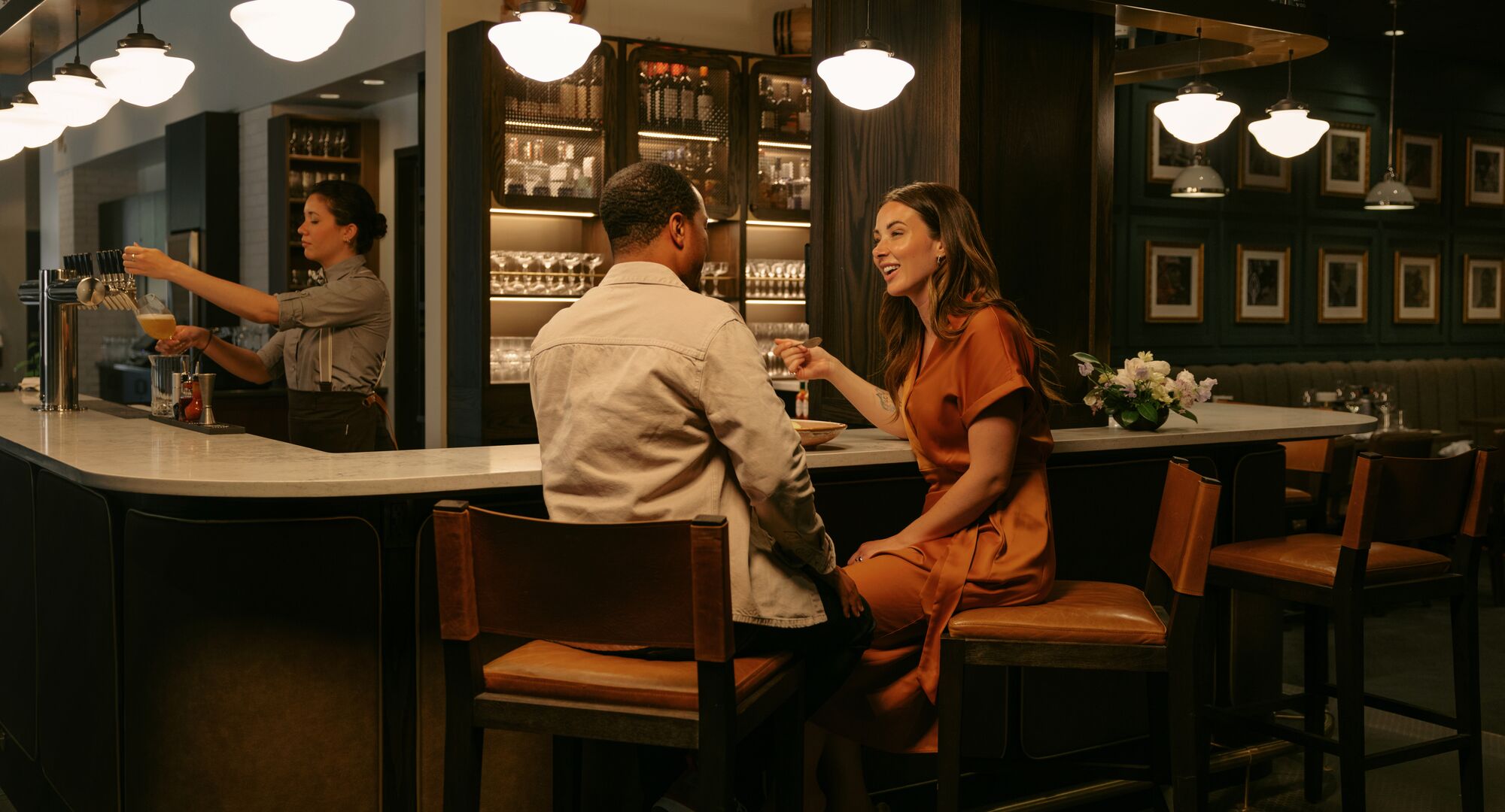 A couple enjoys drinks at the bar at Brazen, a restaurant in Banff National Park