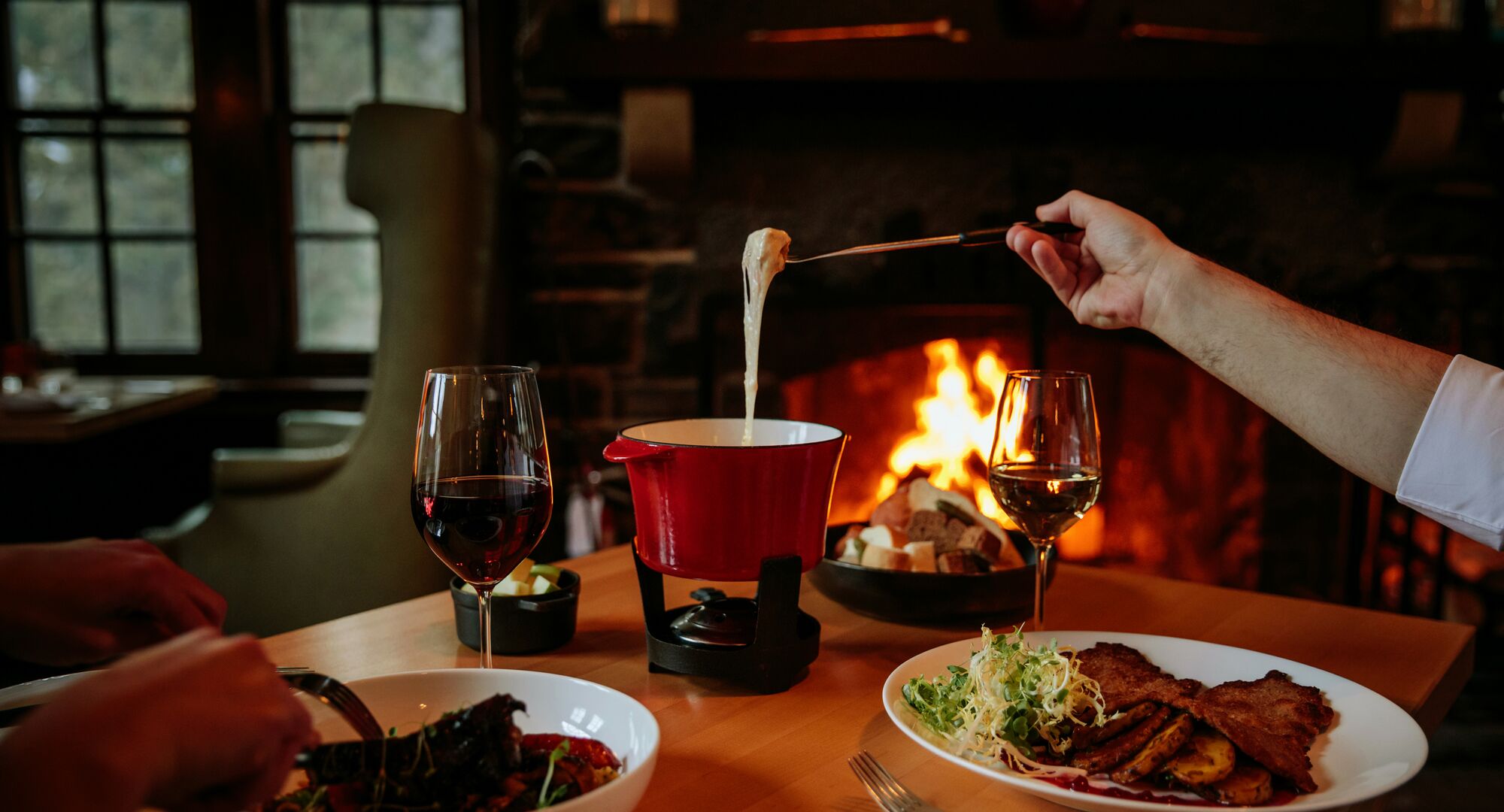 Two people enjoy a meal at the Waldhaus Restaurant & Pub located in the Fairmont Banff Springs Hotel